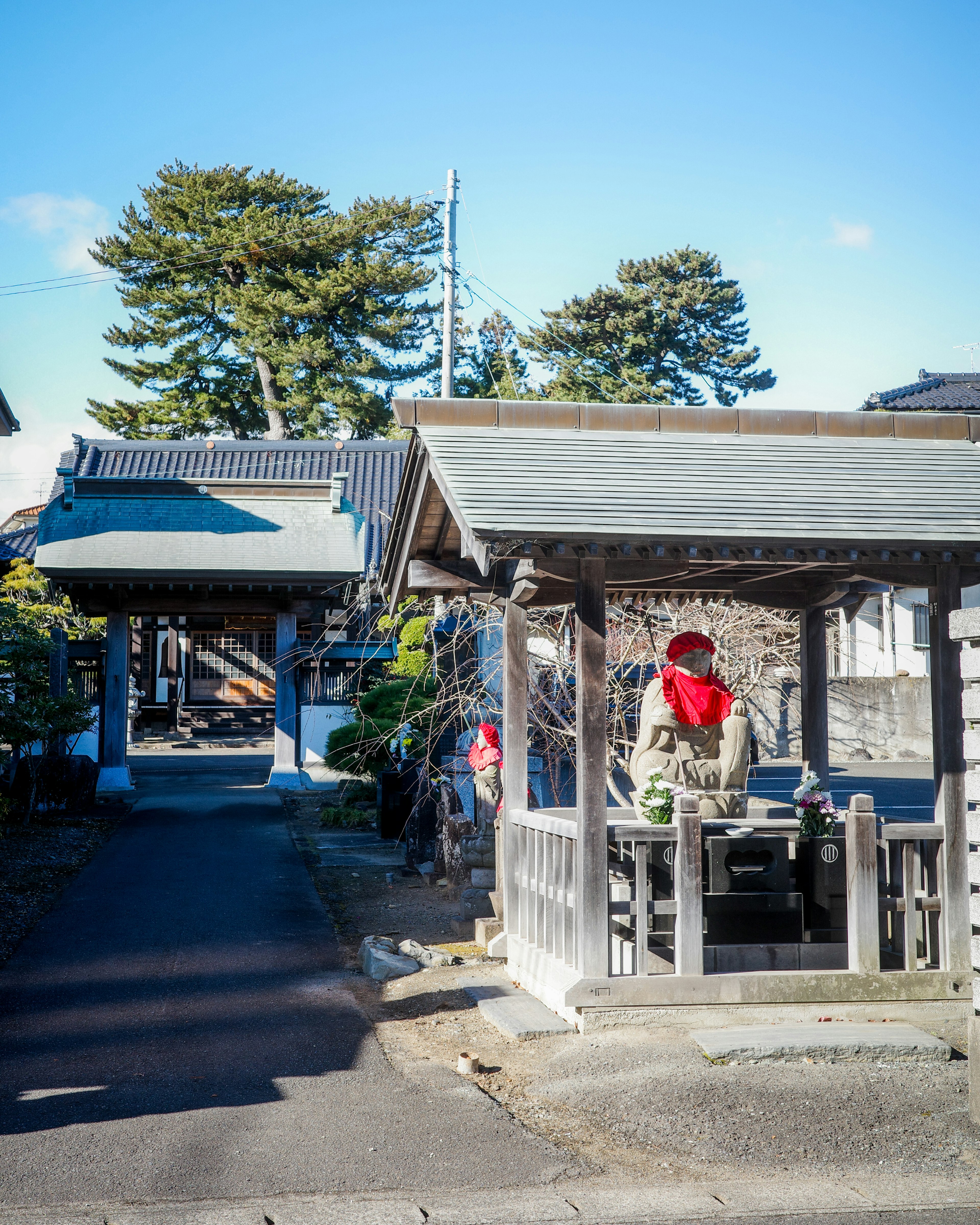 静かな日本の街並みにある伝統的な建物と赤いスカーフを身に着けた人