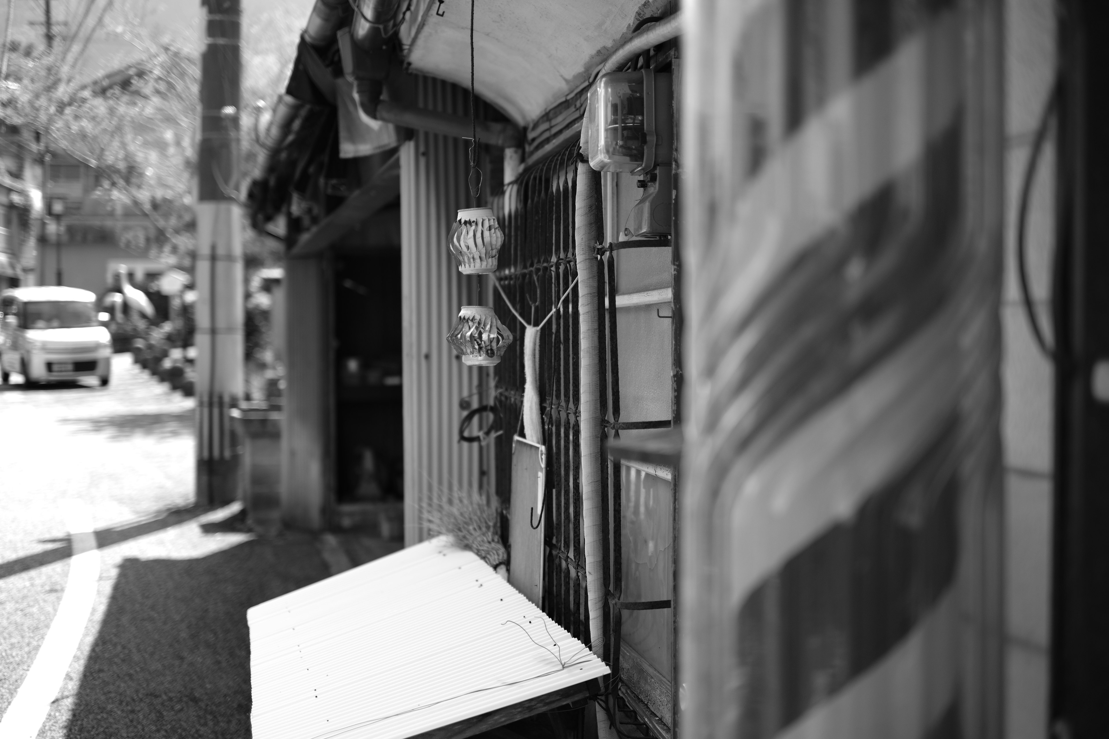 Black and white photo featuring a barber shop sign and window