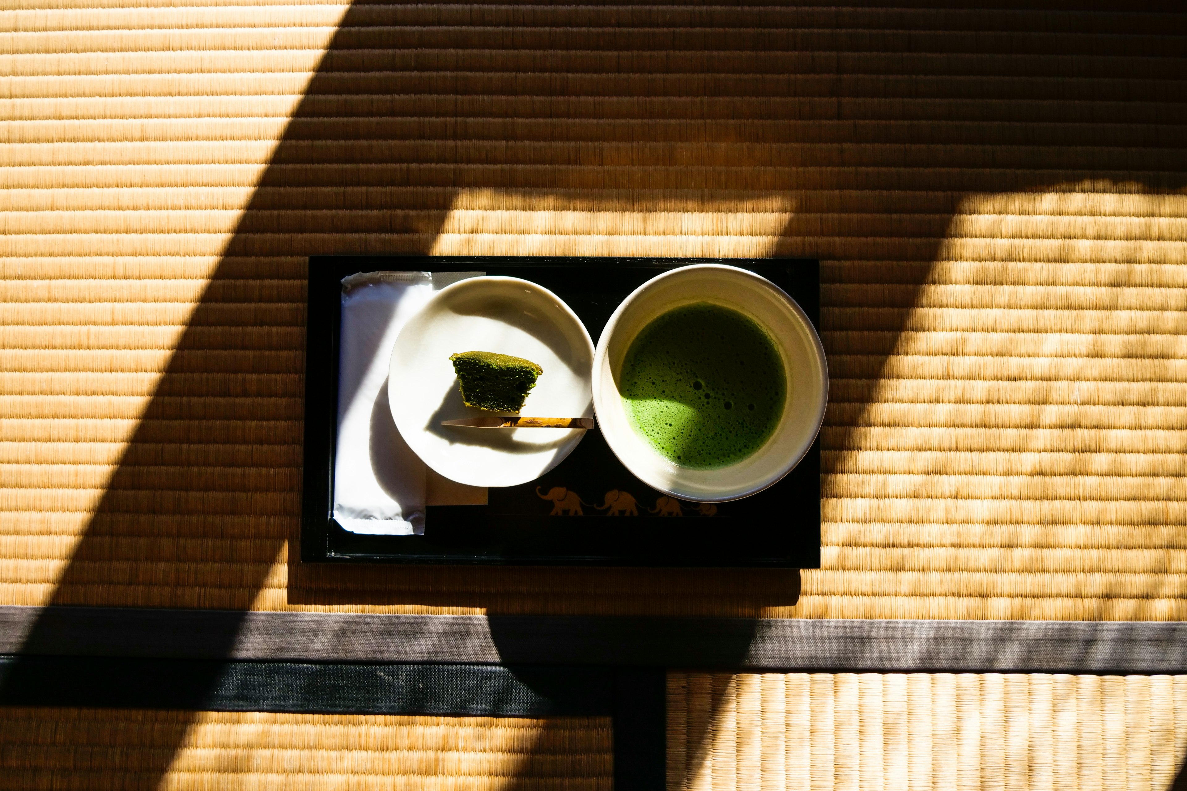 A traditional Japanese tea setup featuring matcha and utensils