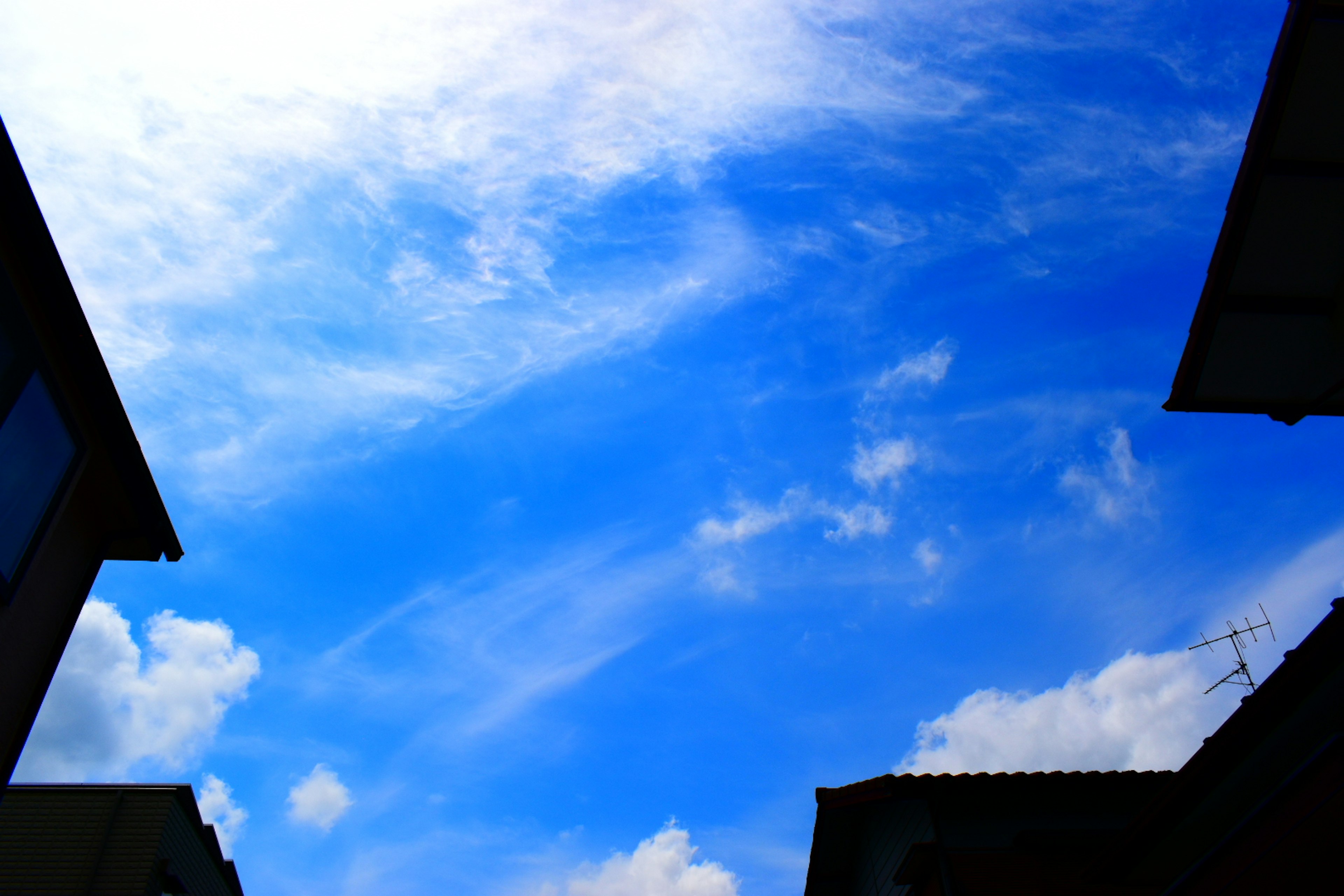 Clear blue sky with scattered white clouds