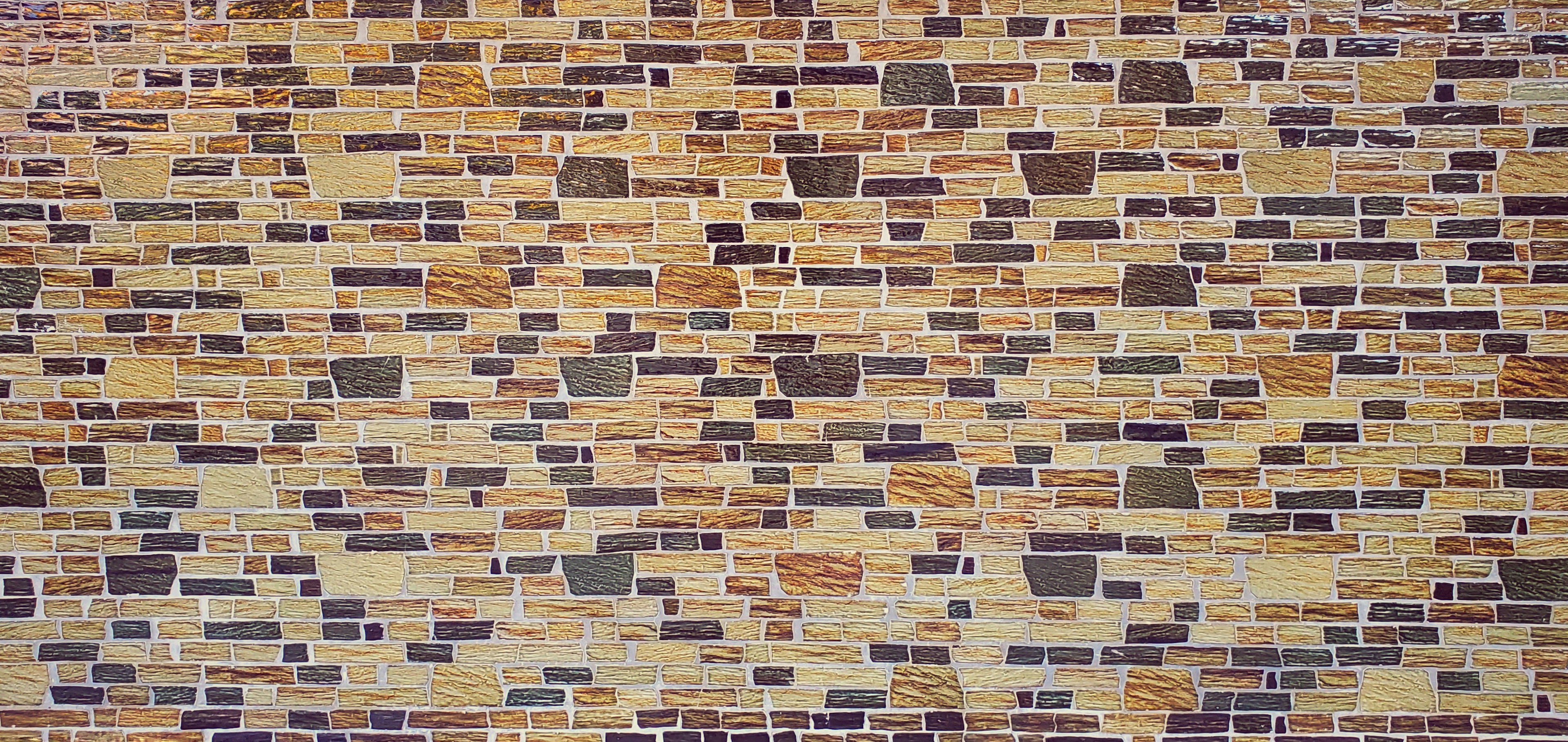 Texture of a wall made of various colored bricks