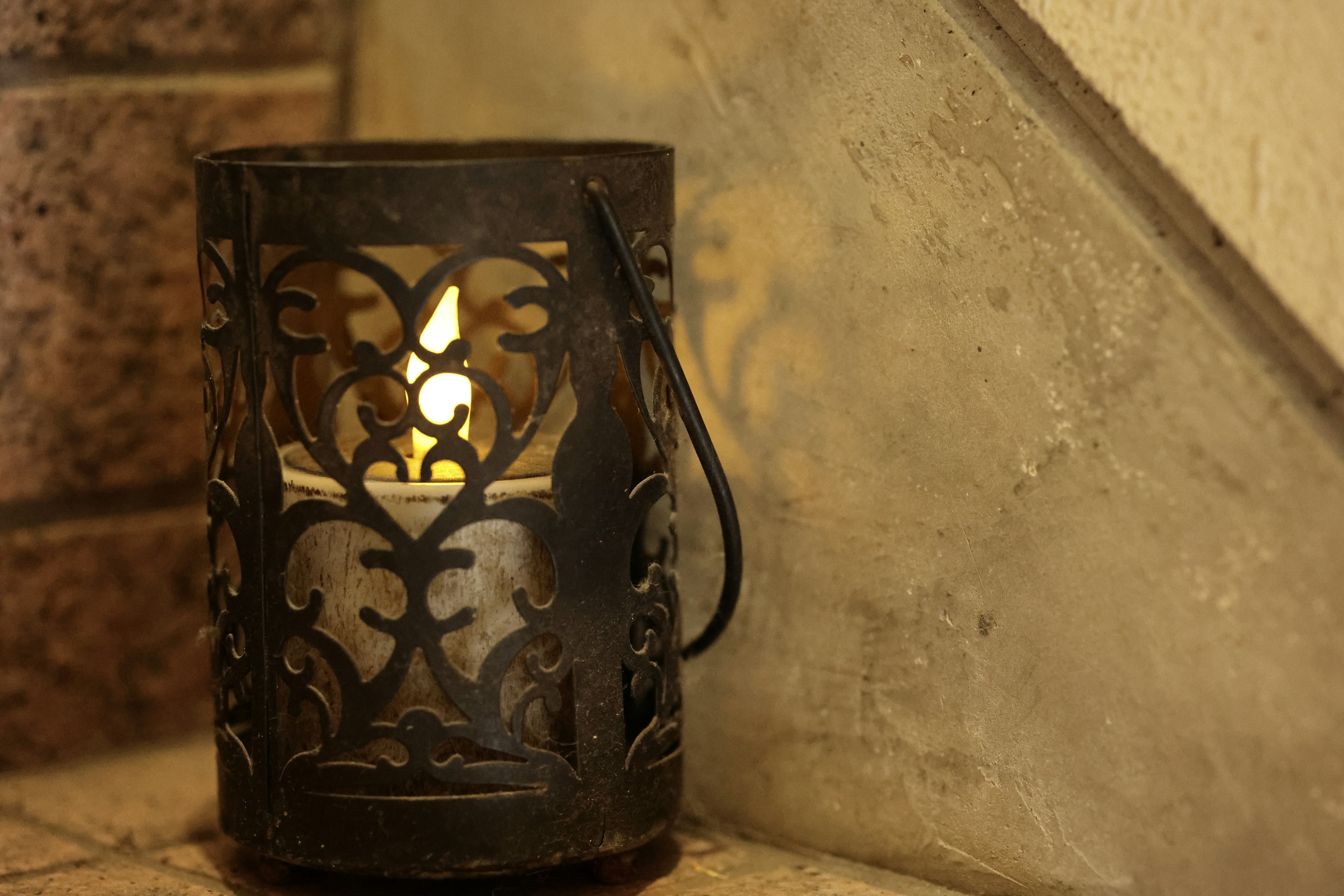 Decorative candle holder placed beside a staircase