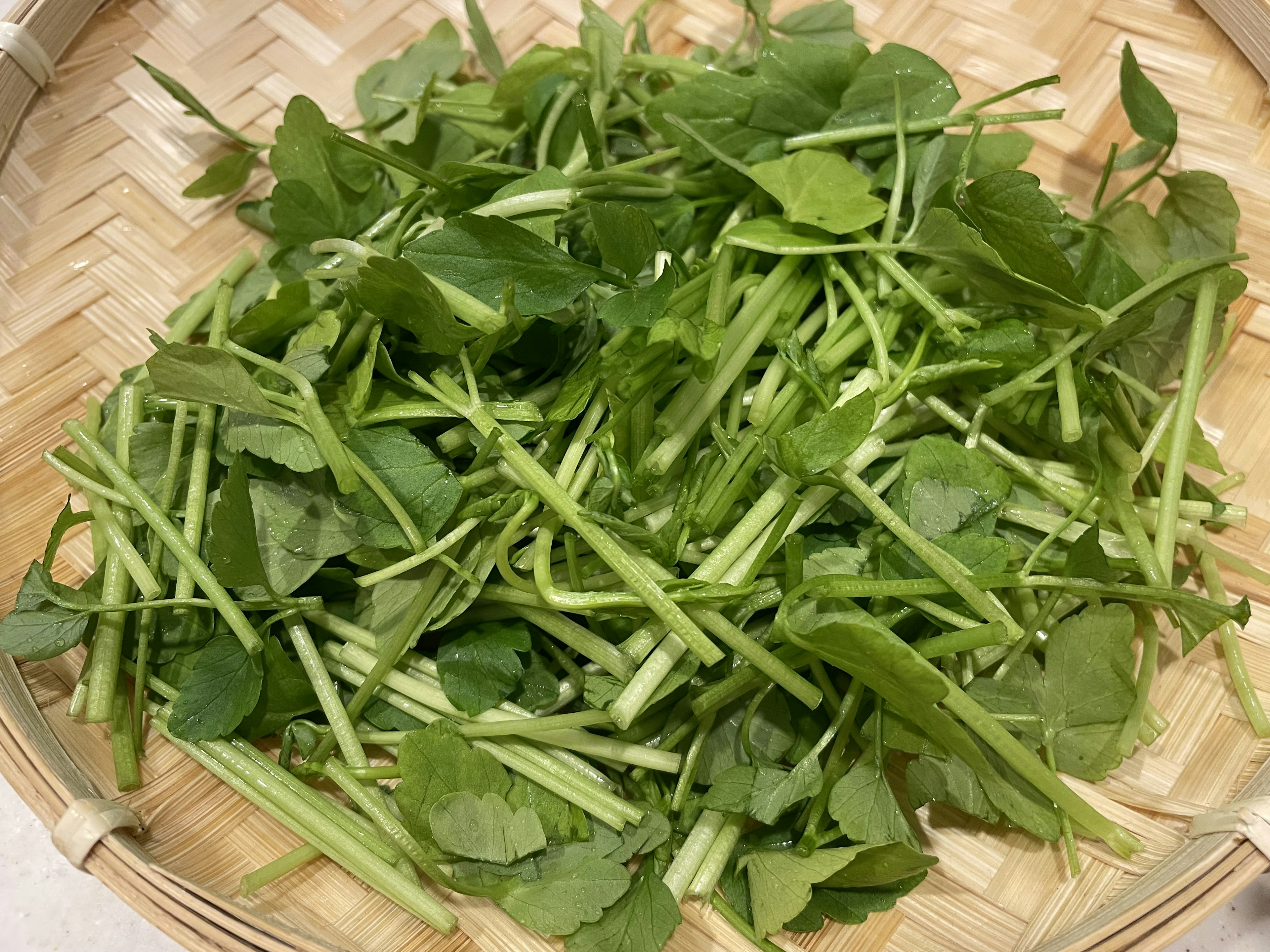 Fresh herbs arranged in a woven basket