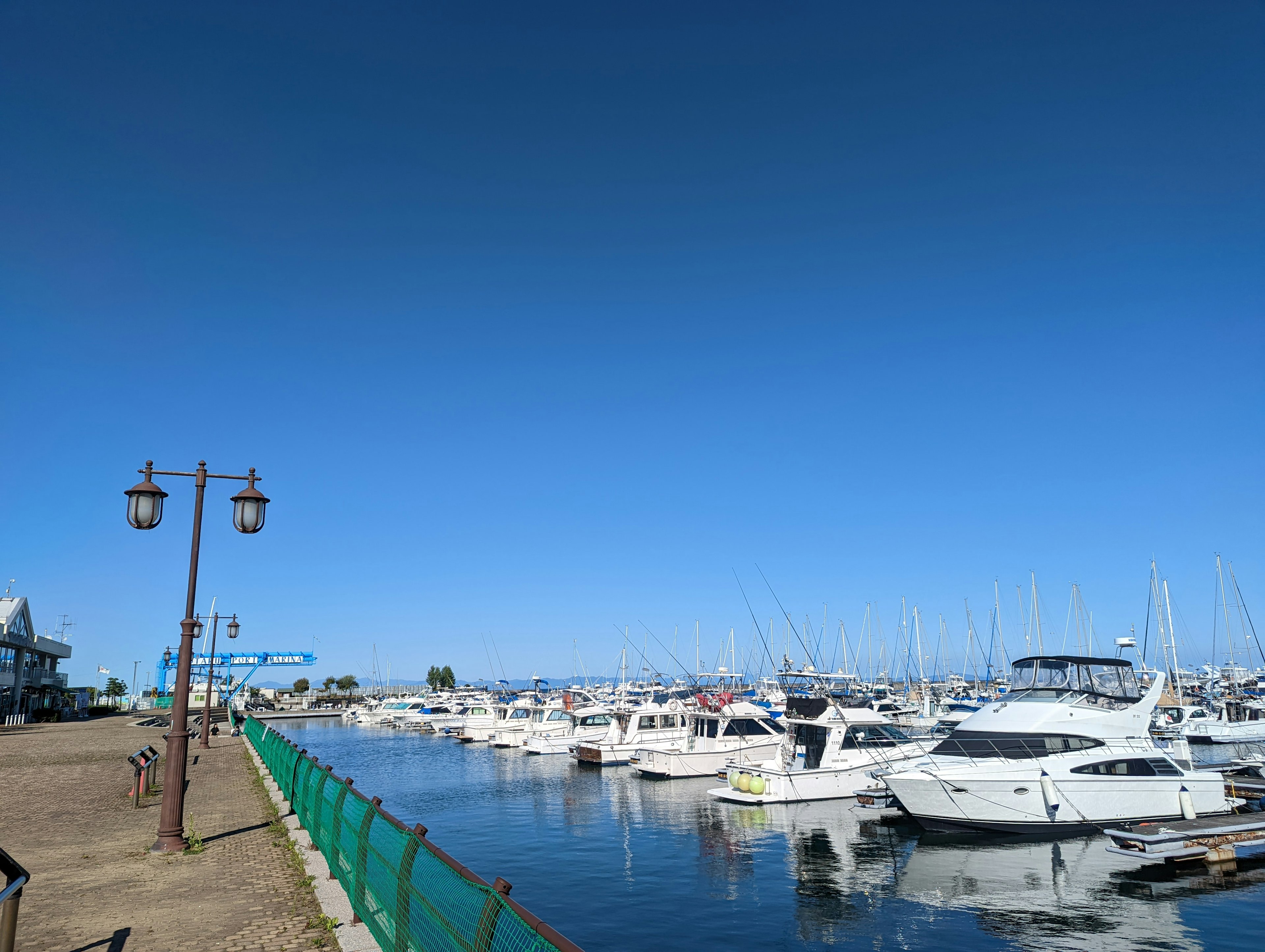 Harbor scene with boats lined up under a clear blue sky