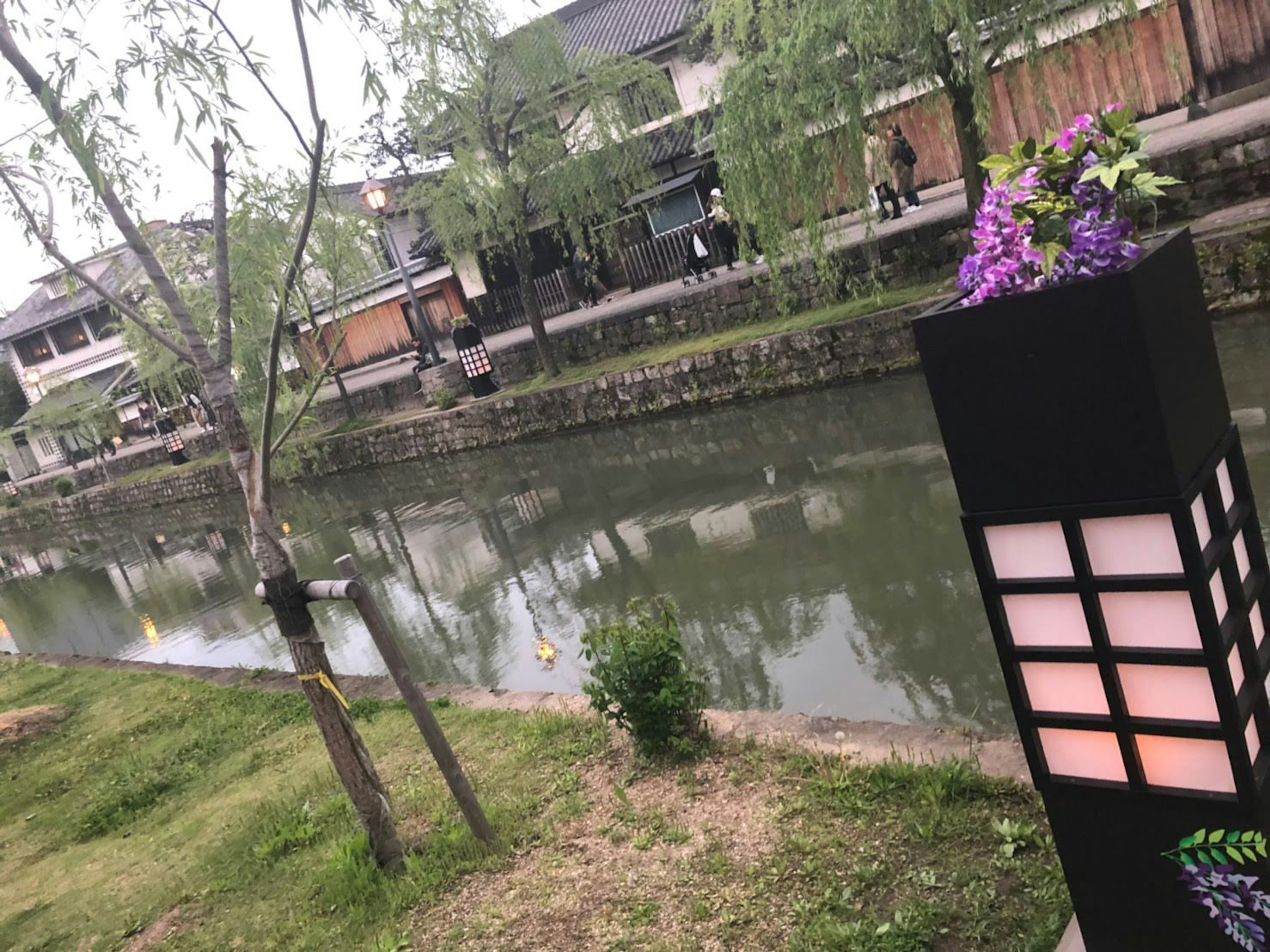 Scenic riverside view featuring a lamp with floral decoration