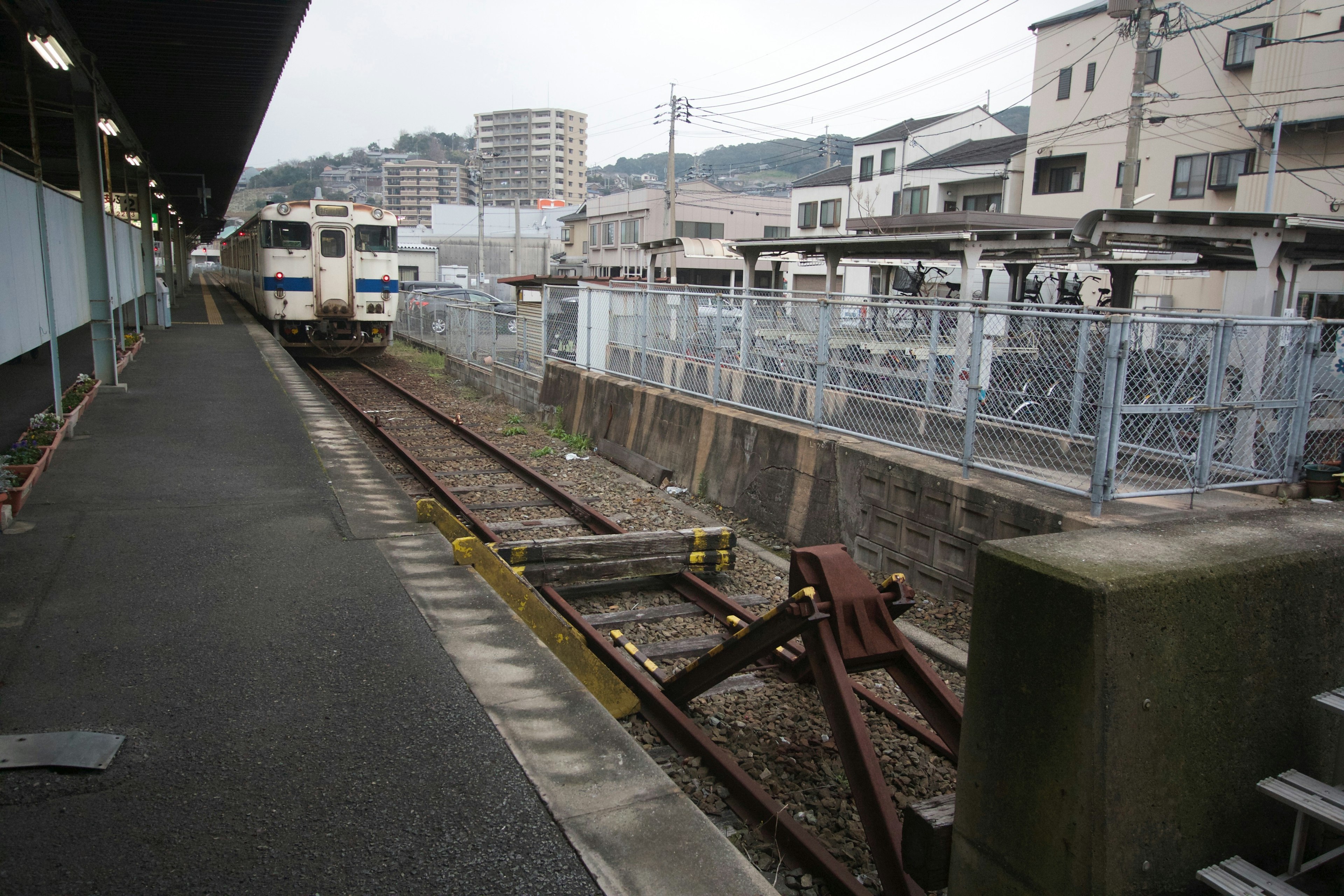 Vue d'une plateforme de gare avec un train qui arrive