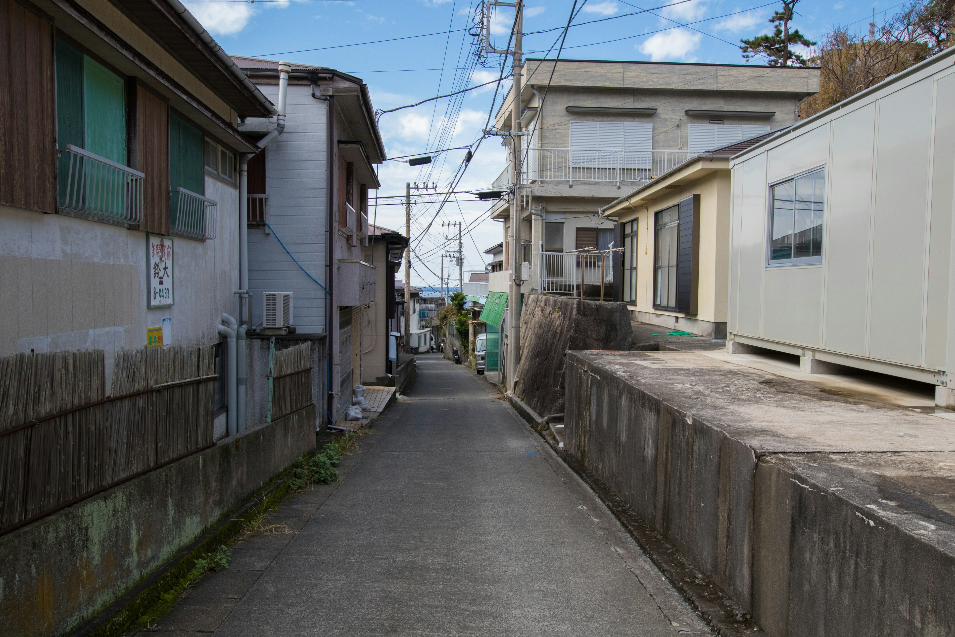 Narrow alleyway view with old houses and blue sky