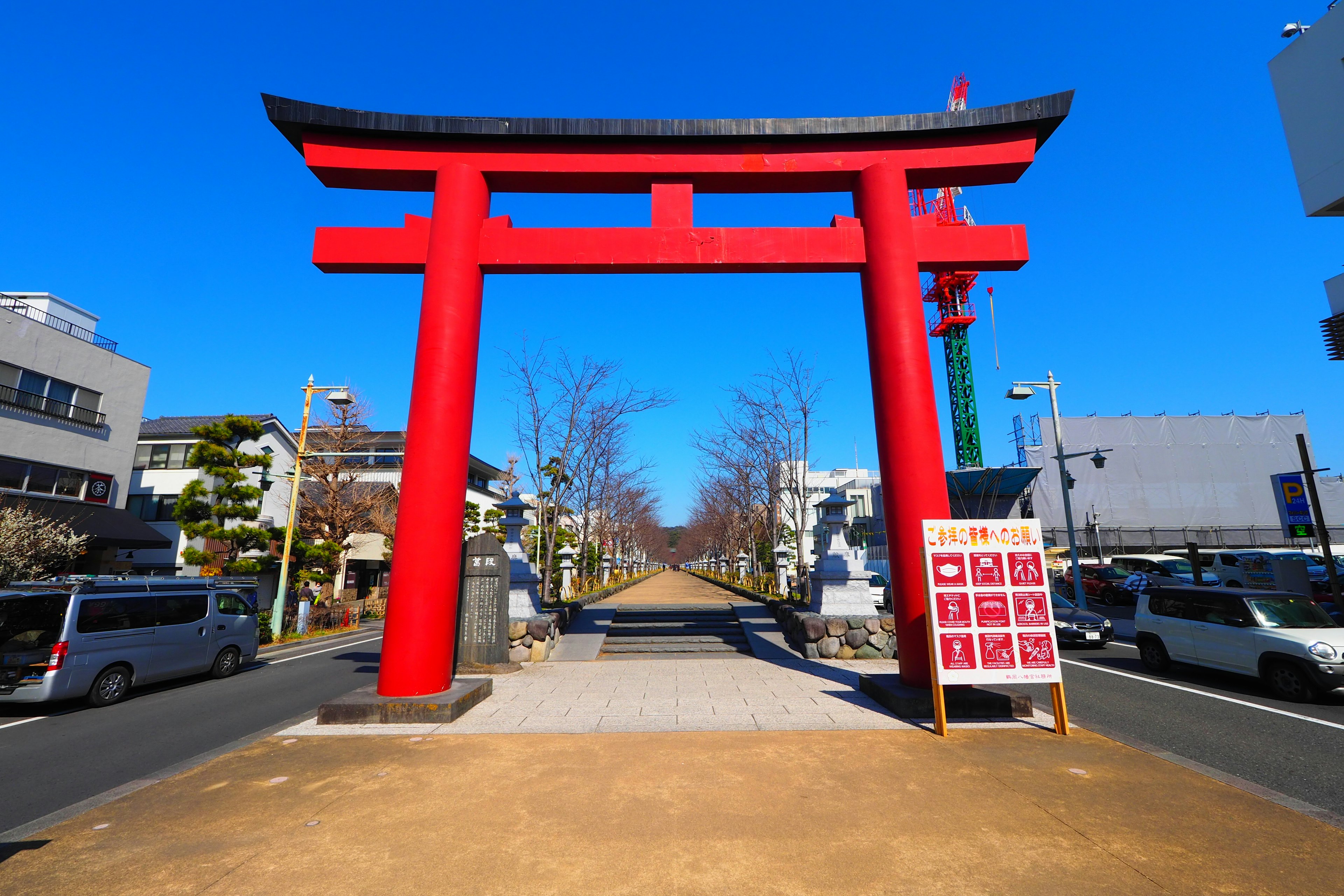 A vibrant red torii gate under a clear blue sky