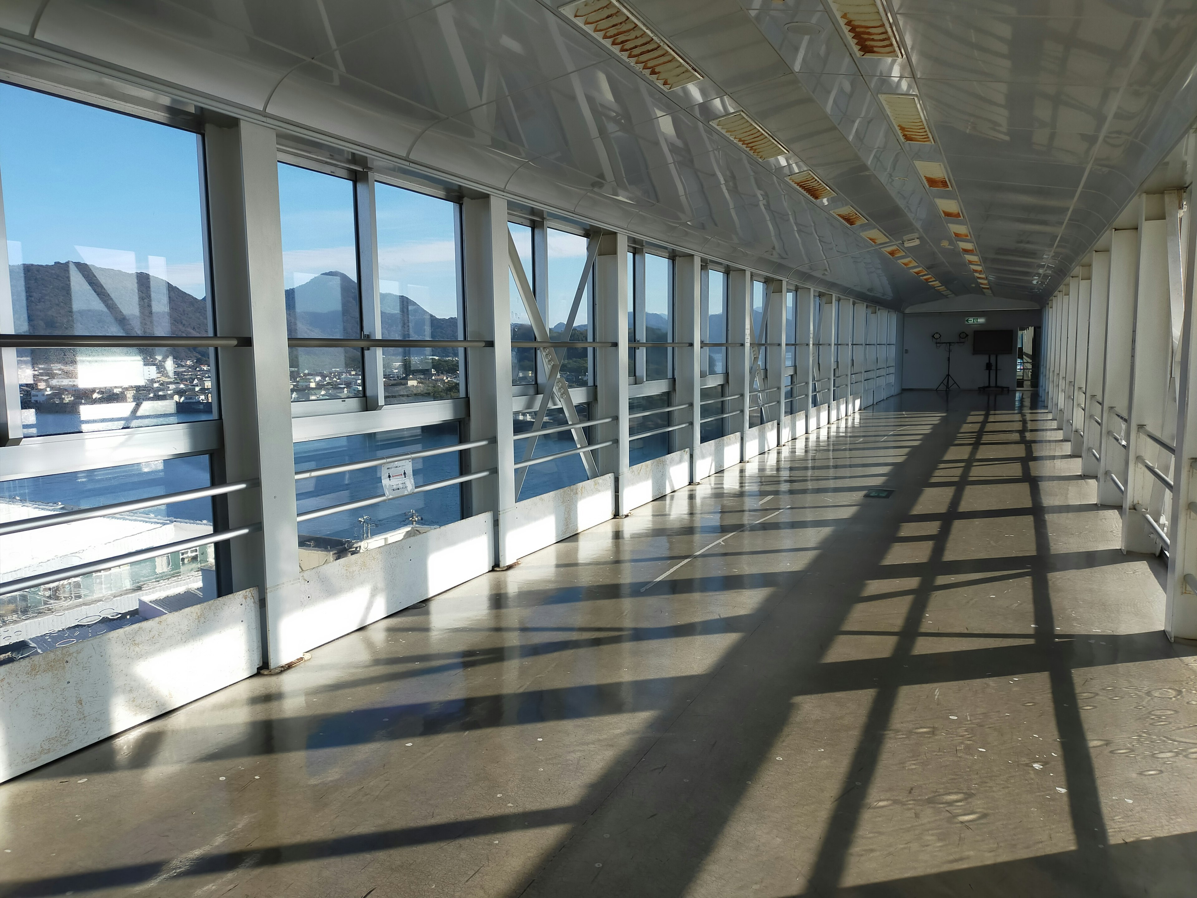 Bright glass corridor with shadows on the floor