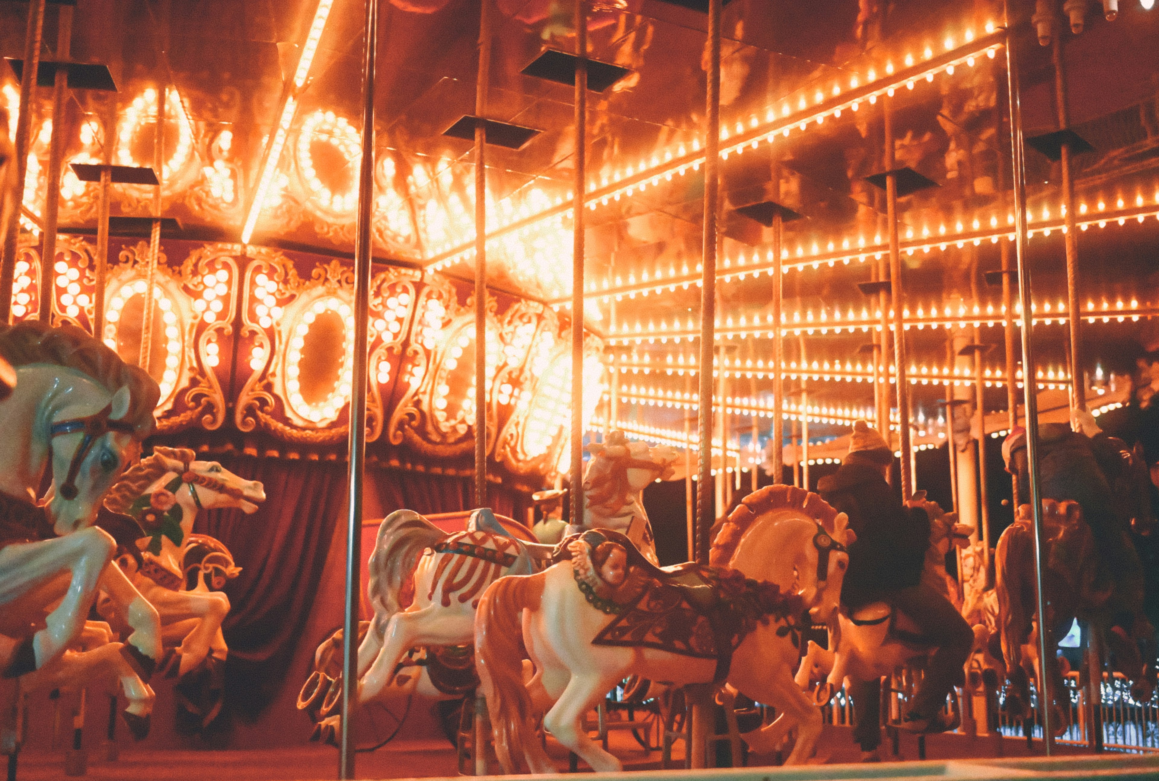 Colorful carousel horses with bright lights