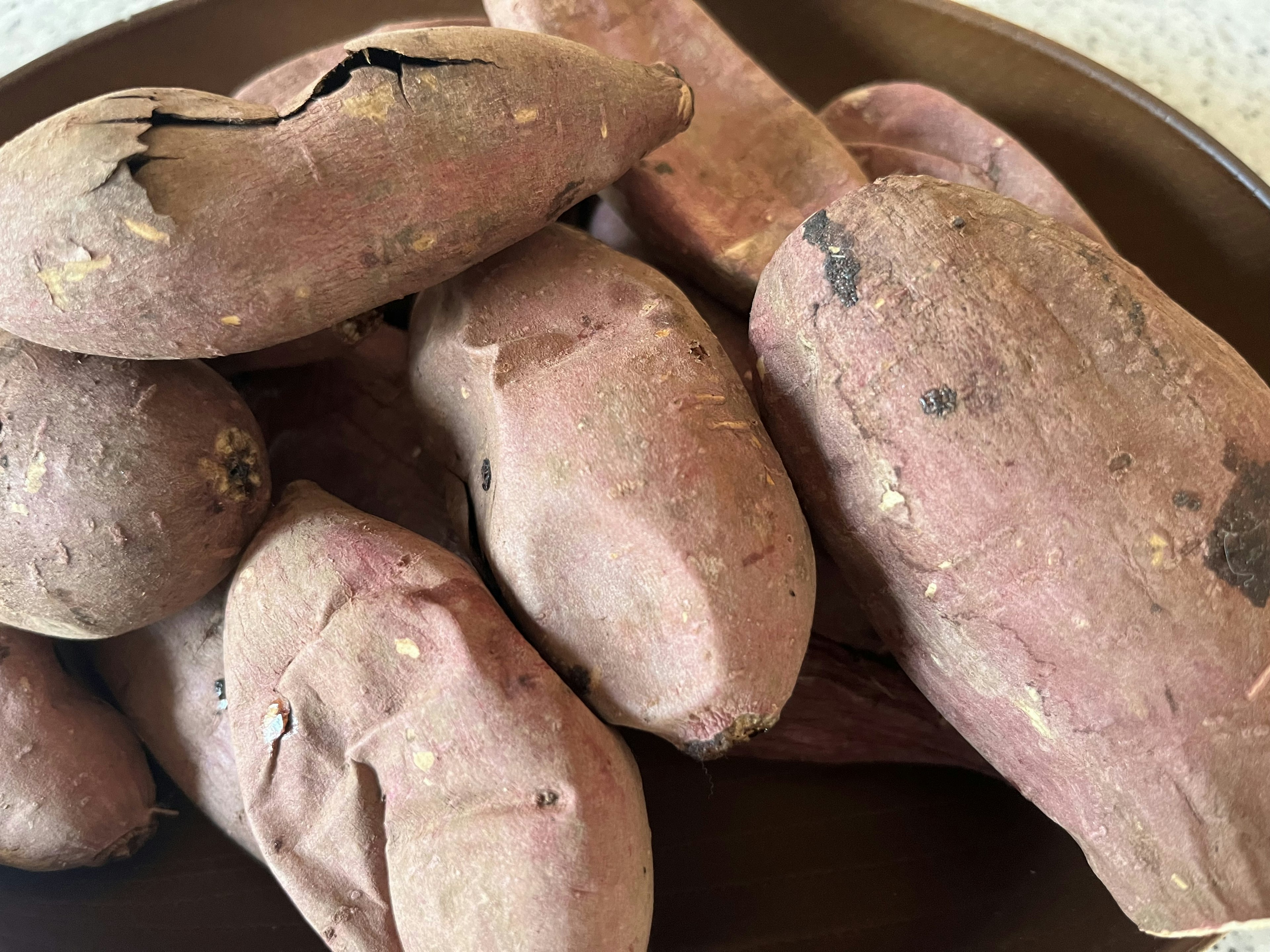 A pile of wrinkled sweet potatoes arranged on a plate