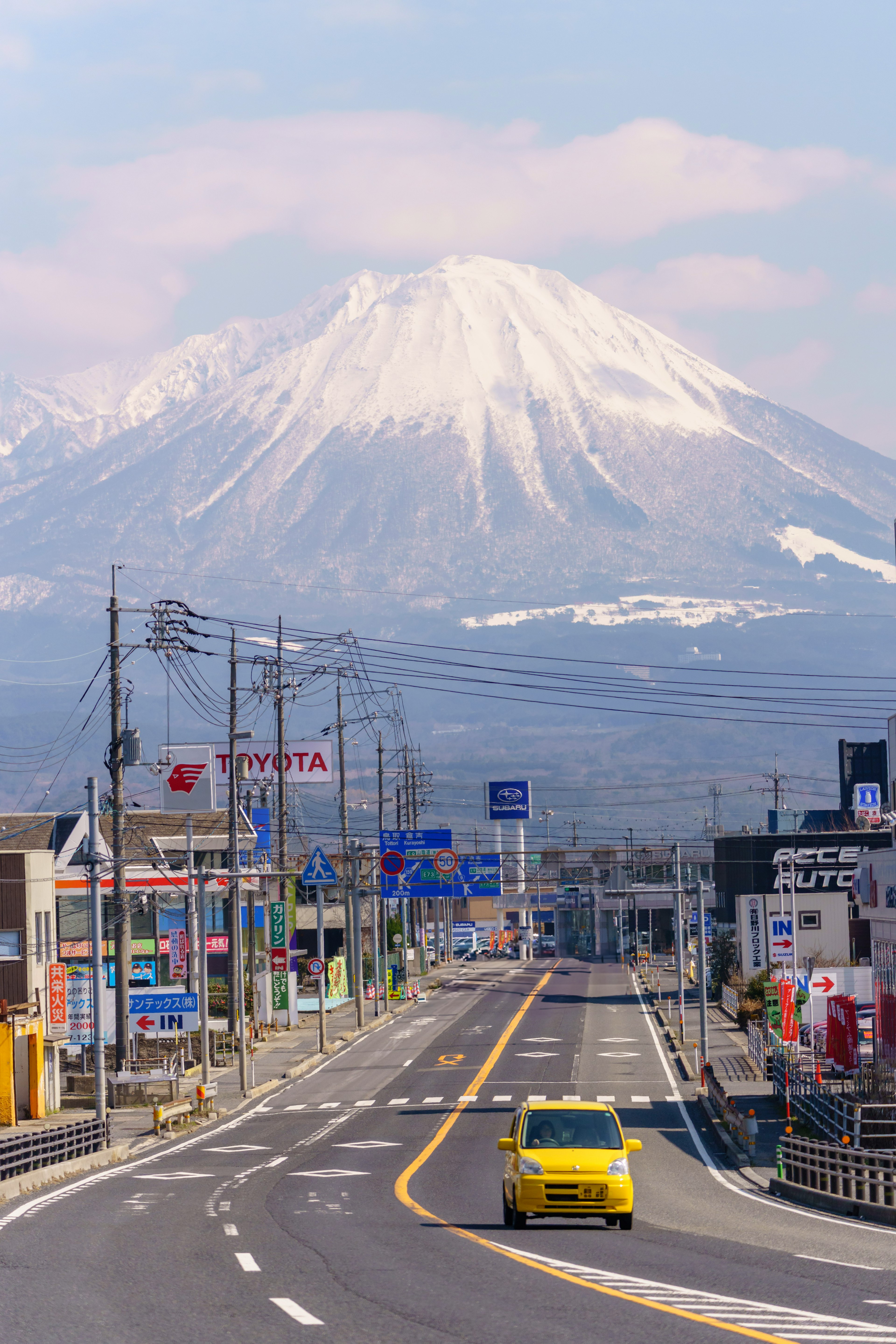 ทิวทัศน์ถนนที่มีภูเขาหิมะและอาคารเมือง