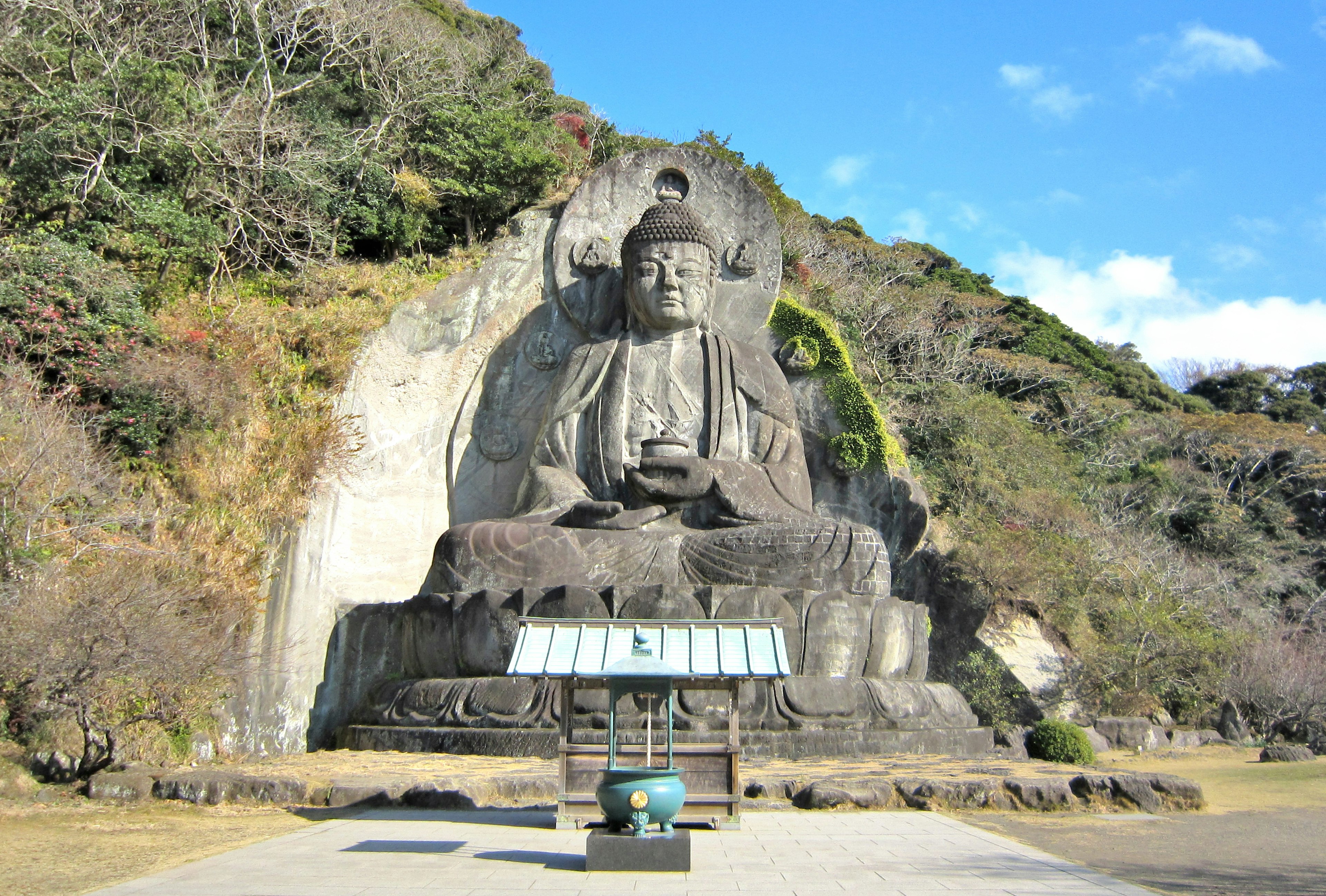 Large Buddha statue carved into a rock face