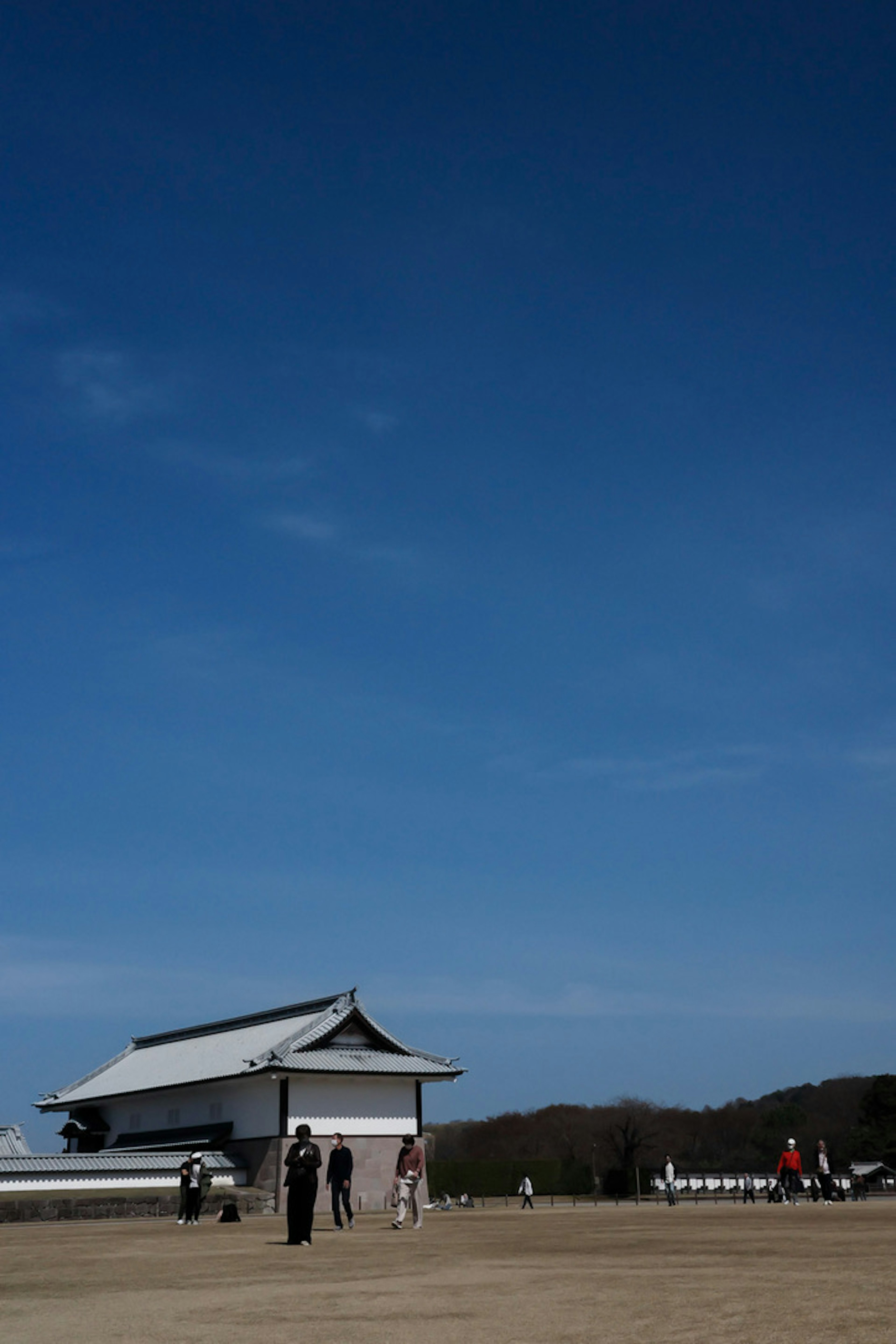 Historic building under a clear blue sky with visitors