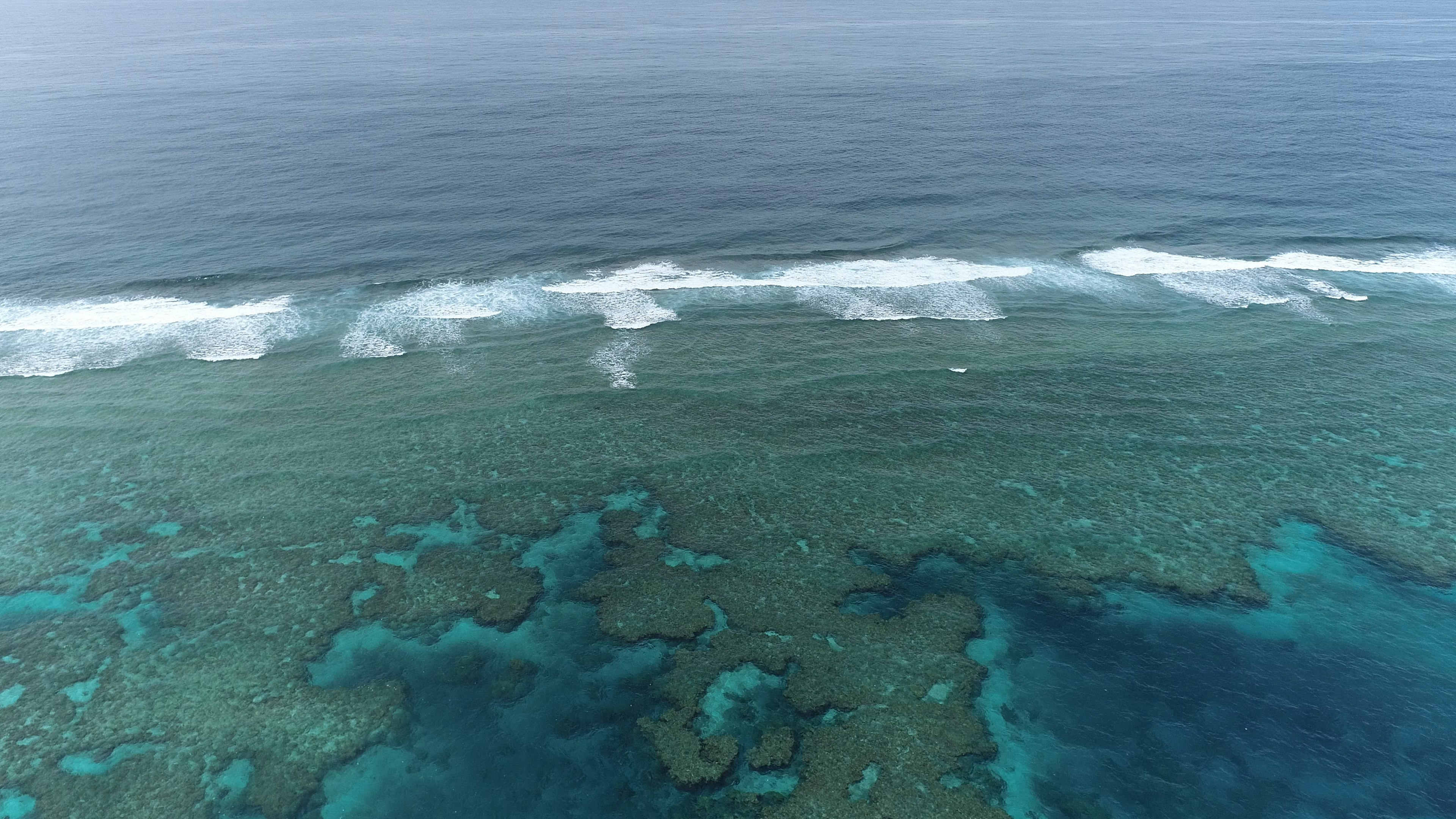 Aerial view of turquoise ocean and coral reefs