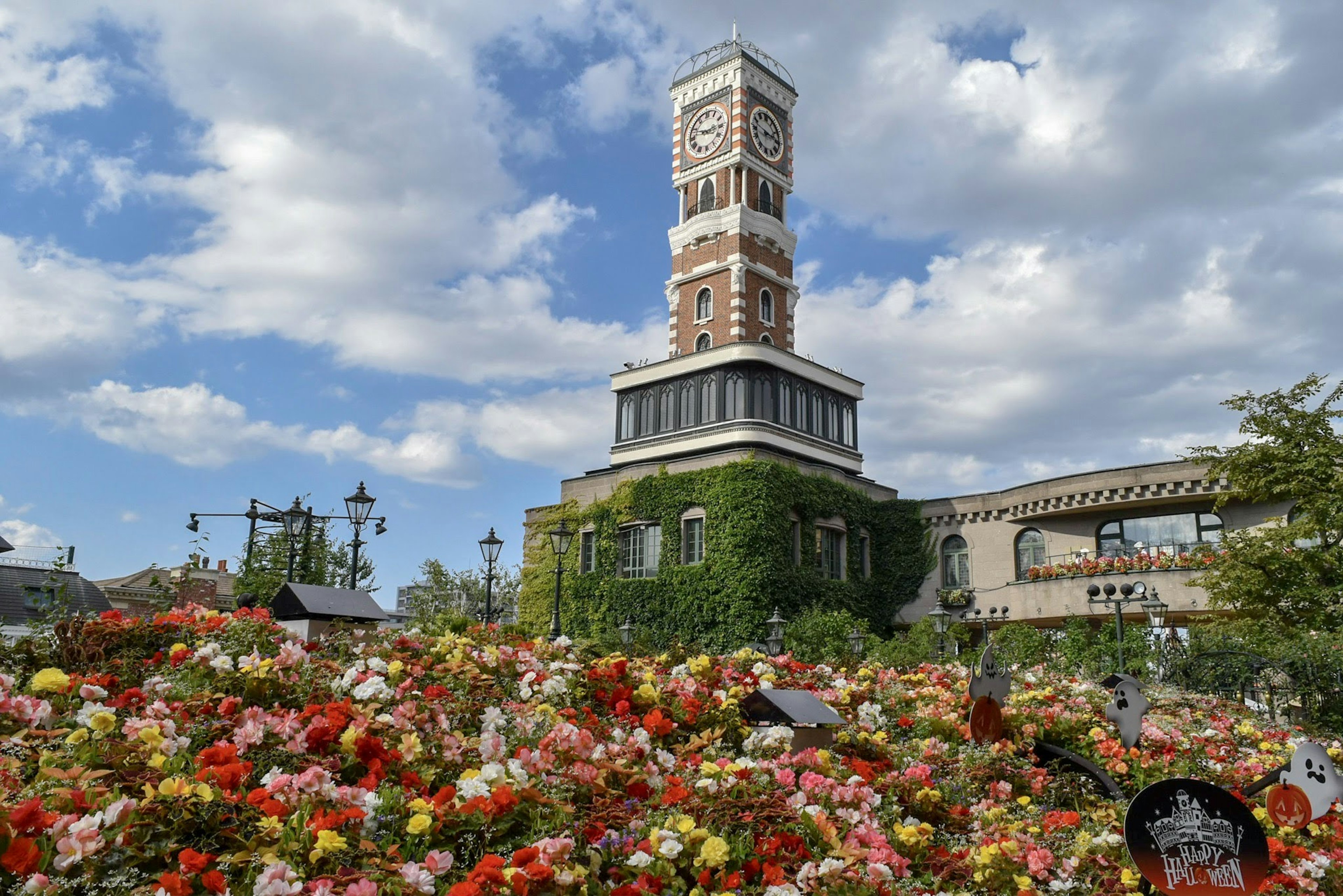 A clock tower surrounded by colorful flowers