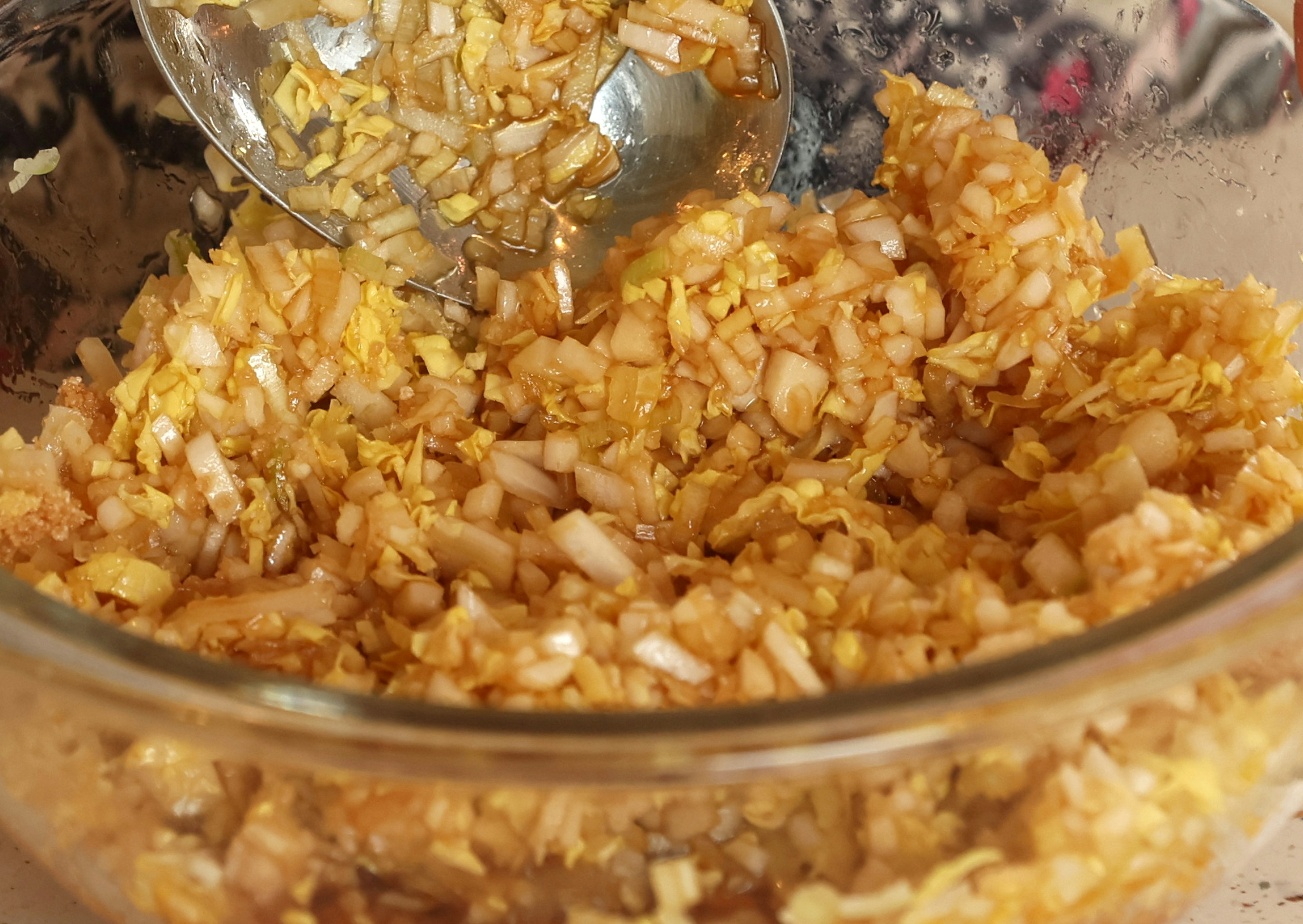 A bowl filled with finely chopped mixture of ingredients