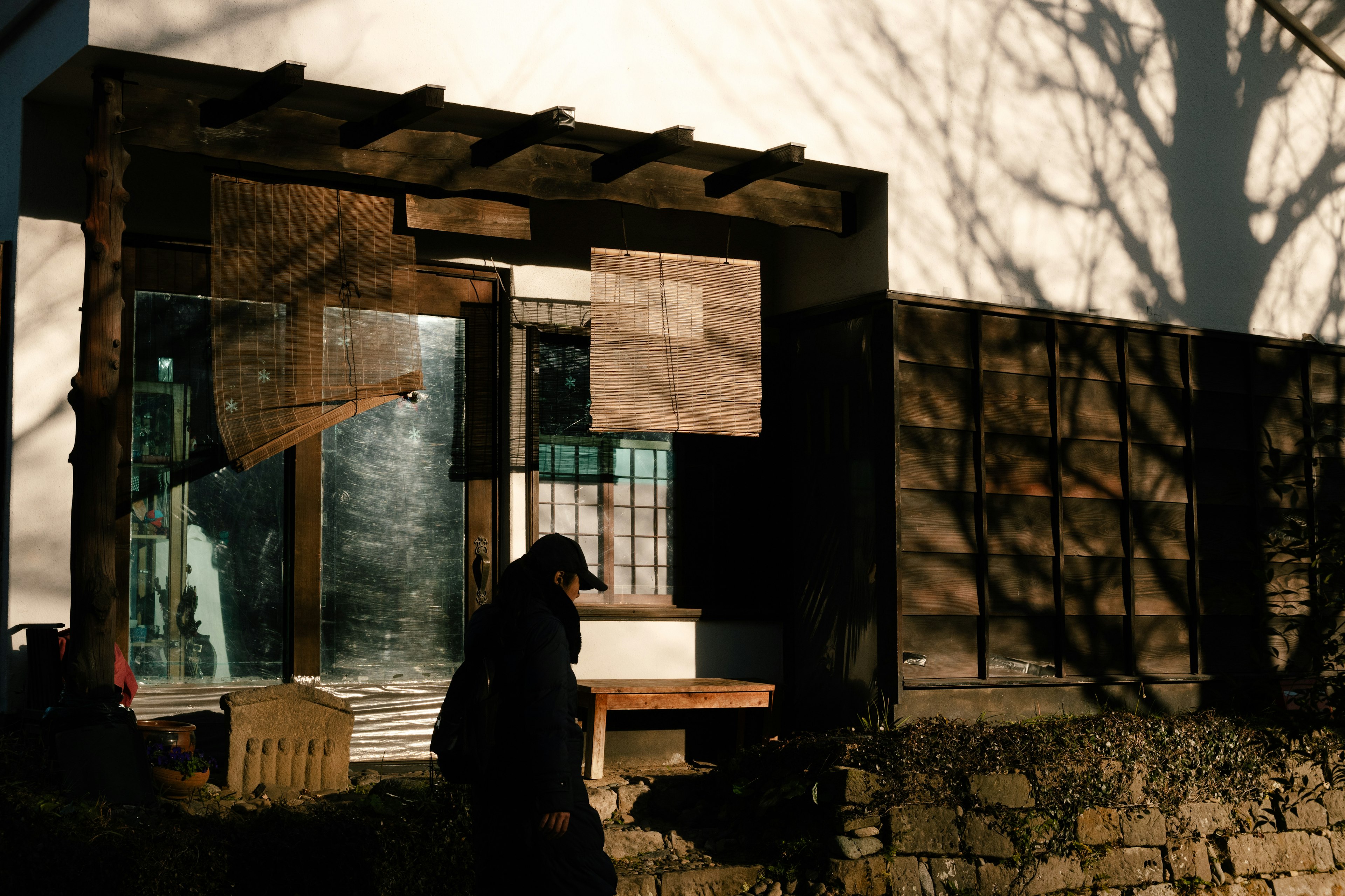 Facade of a wooden house with shadows reflecting on the windows