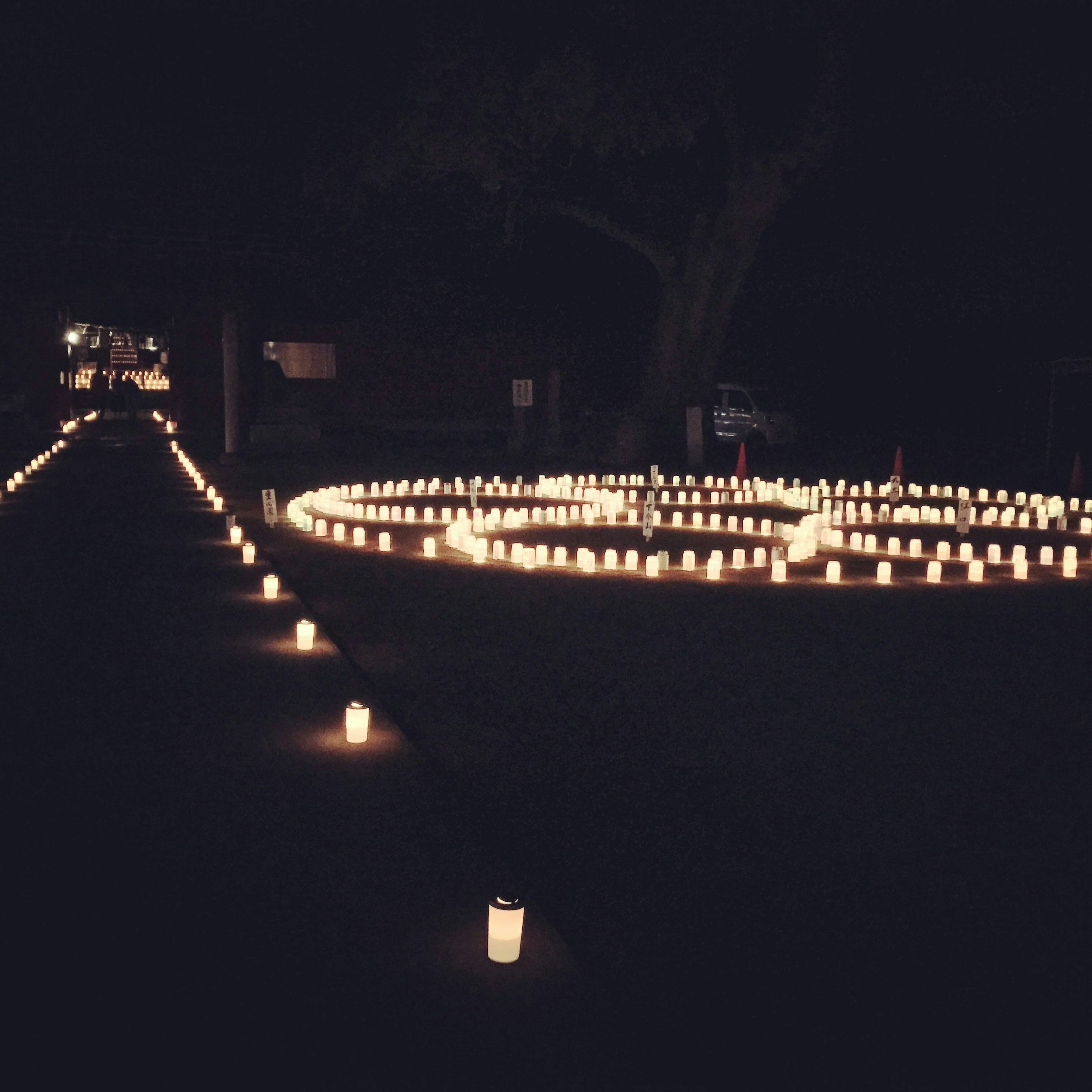 A scene with glowing candles arranged in a circular pattern against a dark background