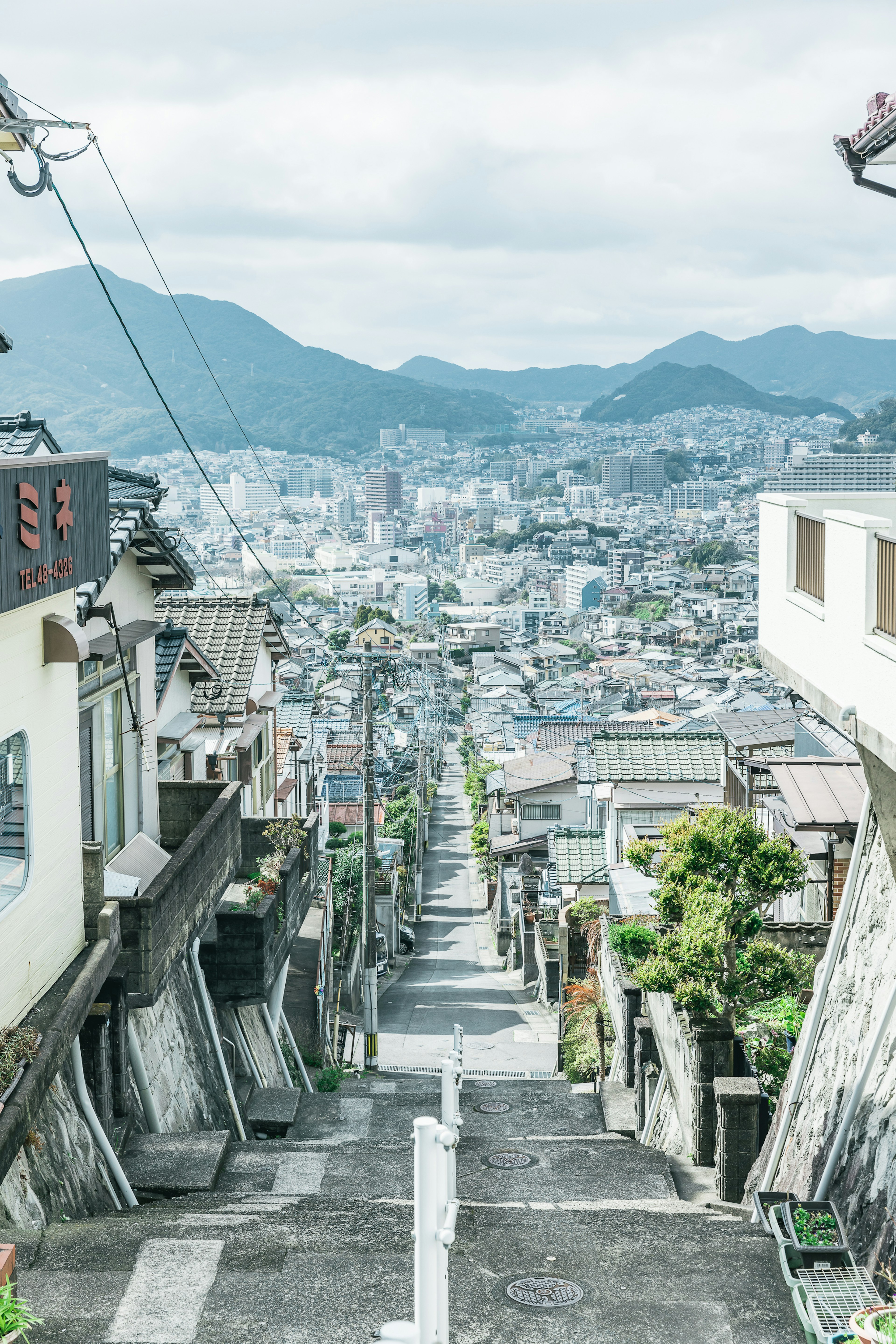 Narrow sloped street with a view of the cityscape