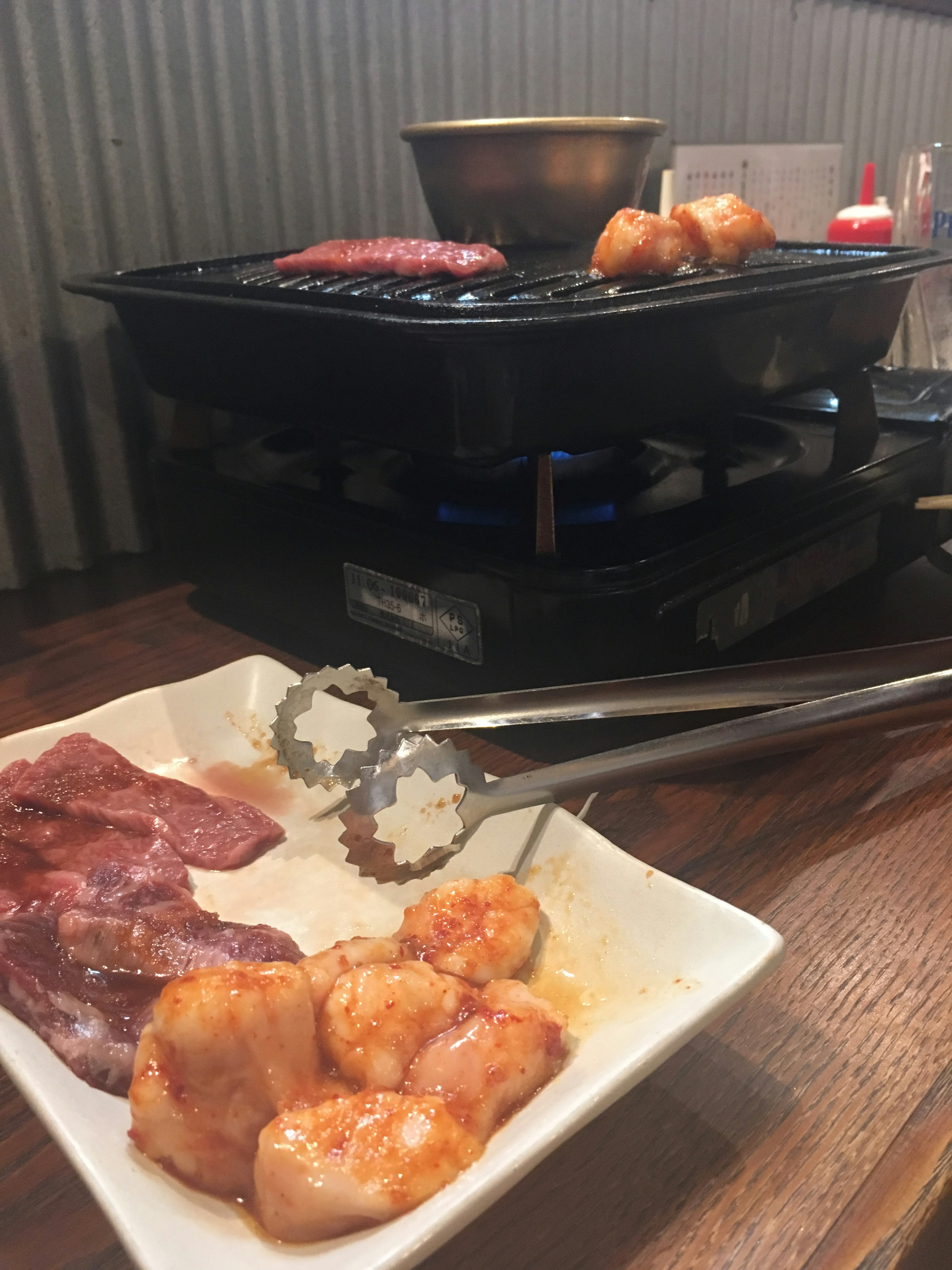 Grill with assorted meats and dipping sauce on a plate