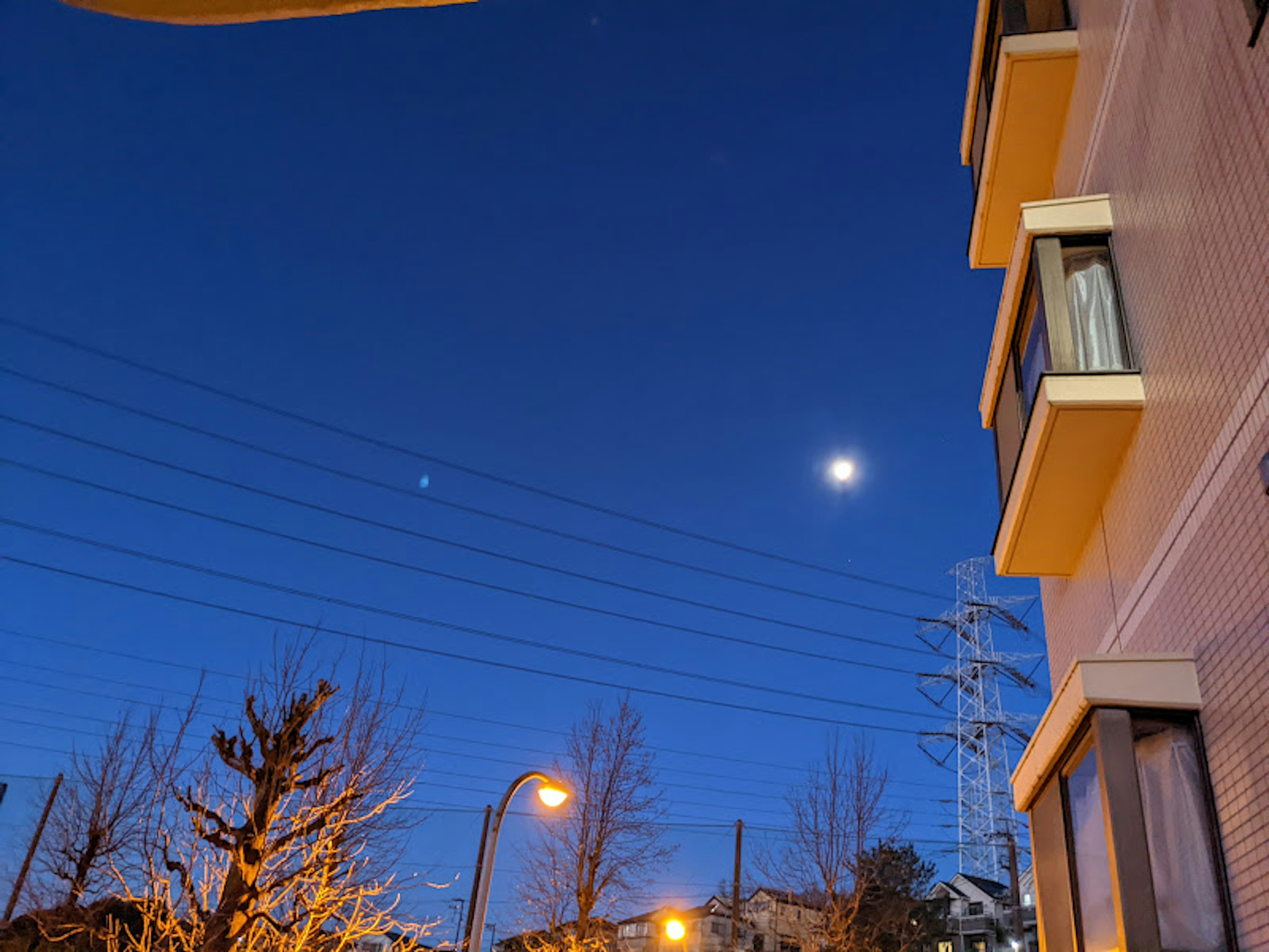 Night sky with bright moon and star visible