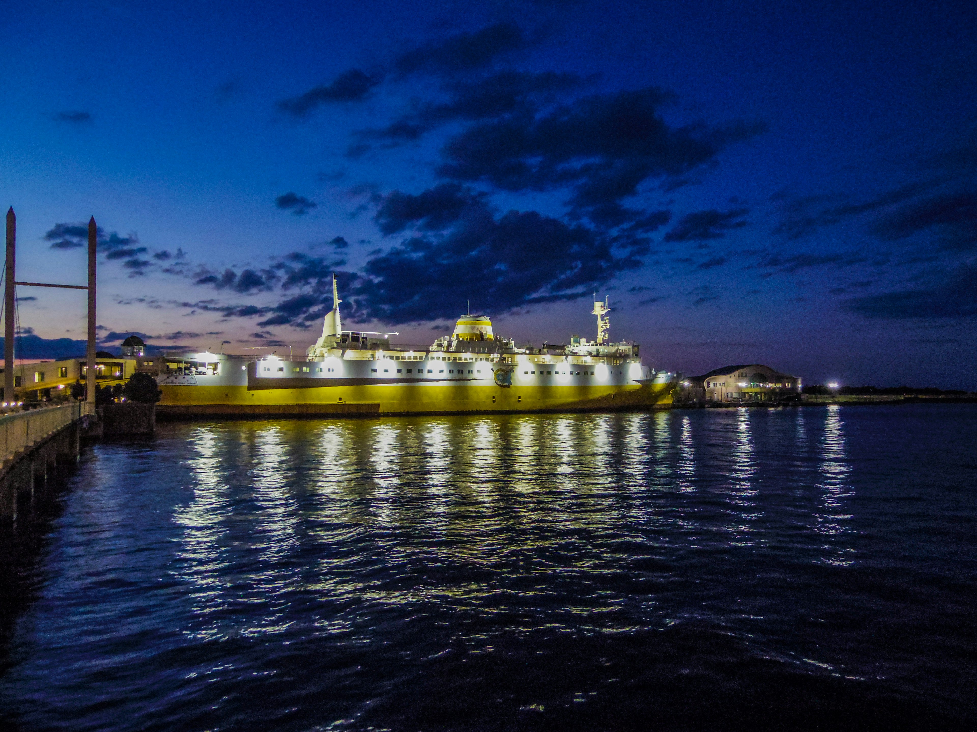 Bright ship illuminated at night on calm waters