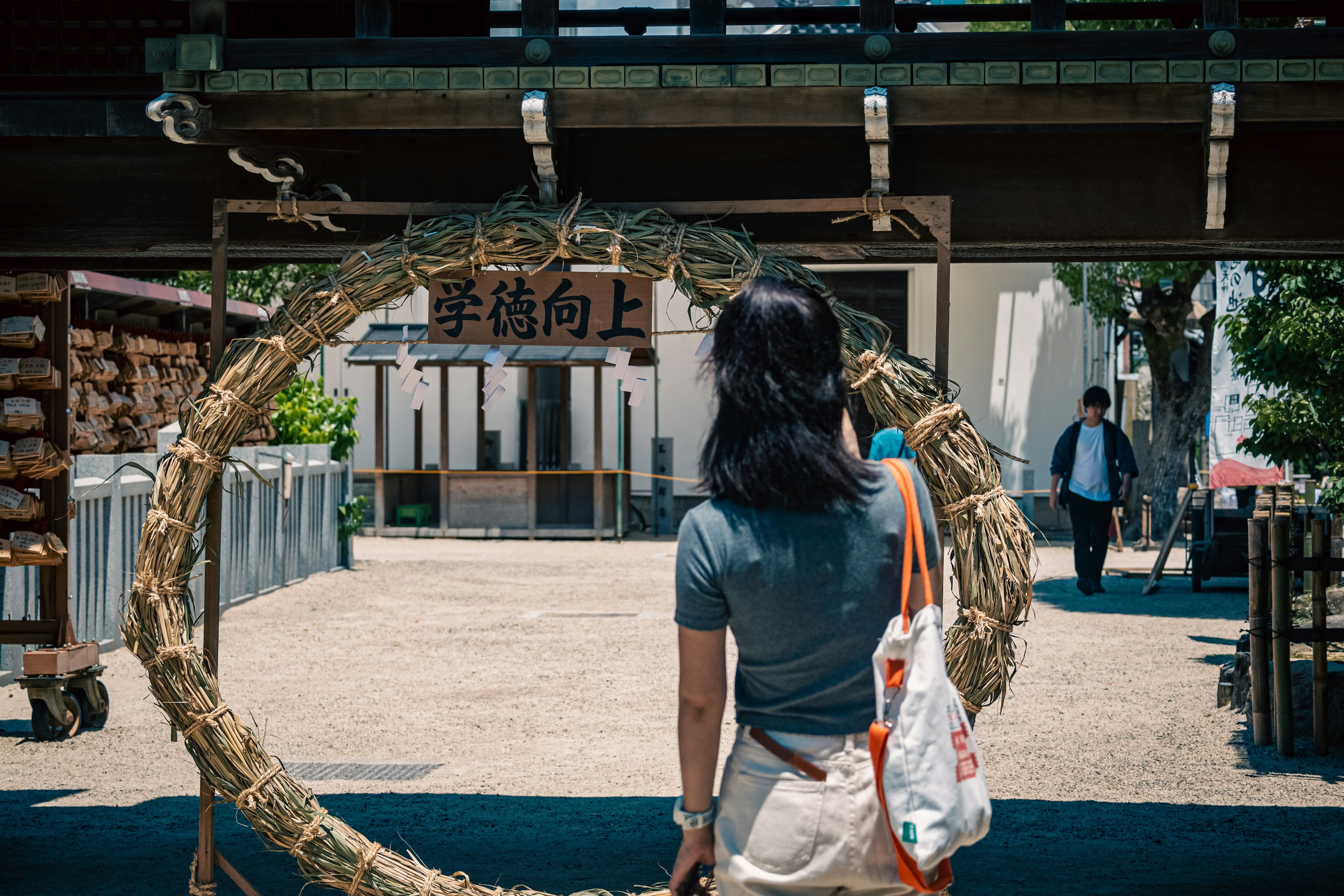 A woman standing in front of a straw ring