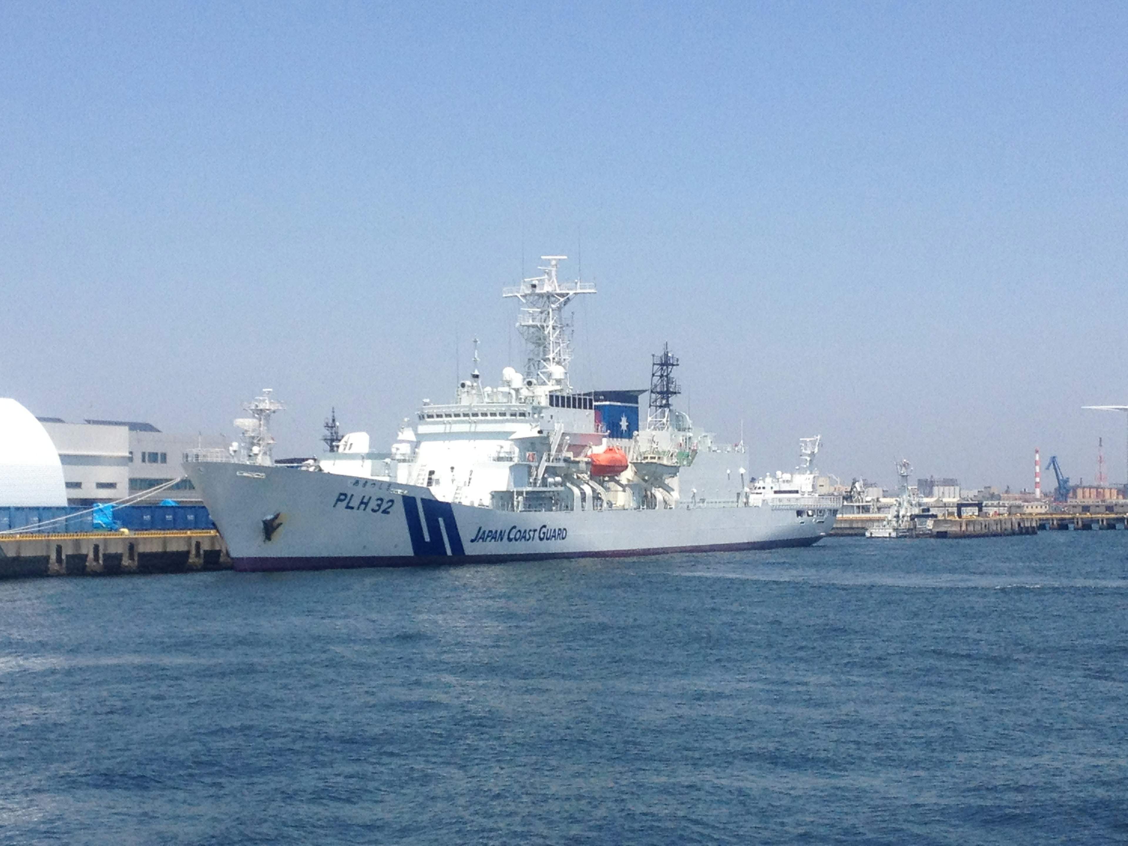 White coast guard ship docked at the port