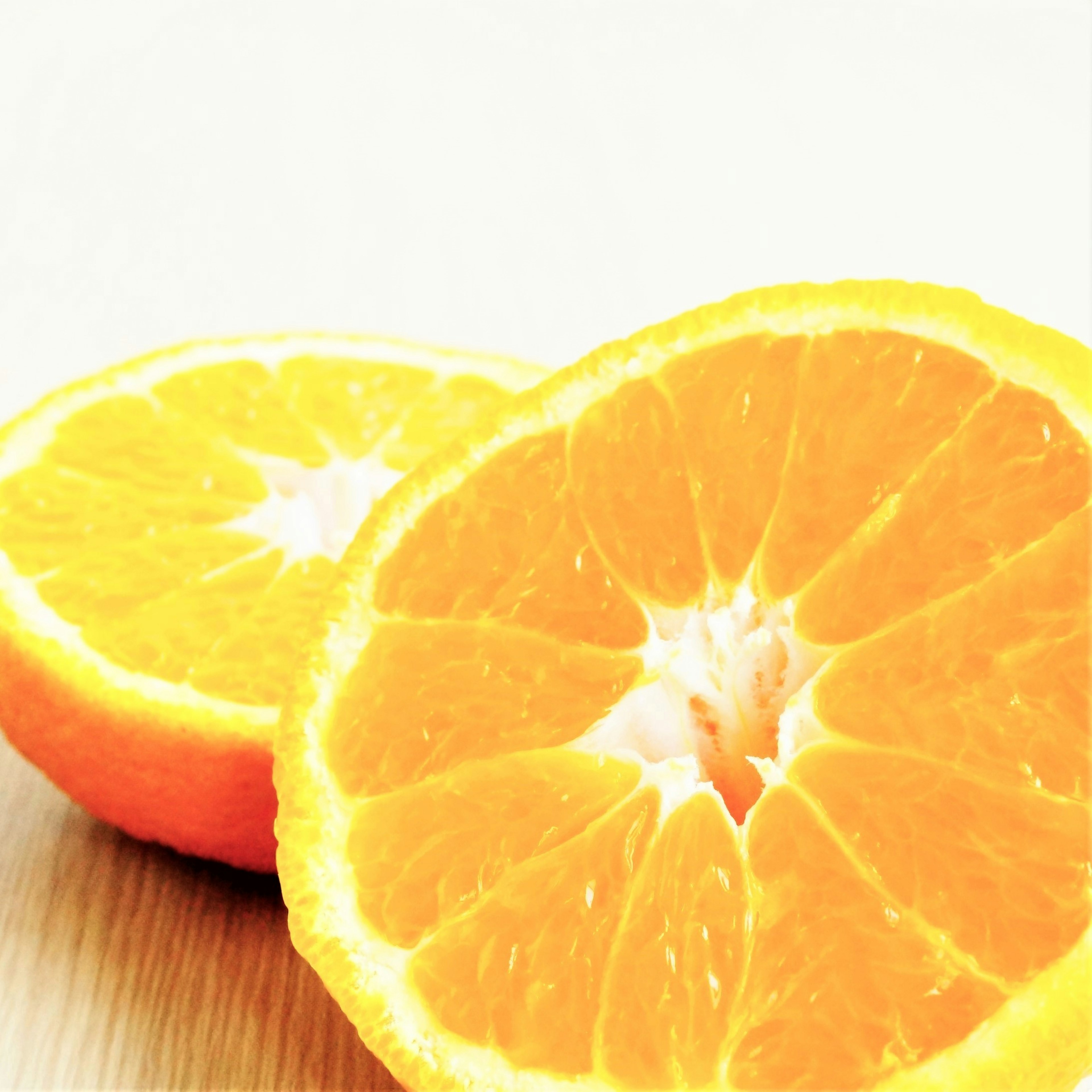 Vibrant orange fruit halves placed on a wooden table