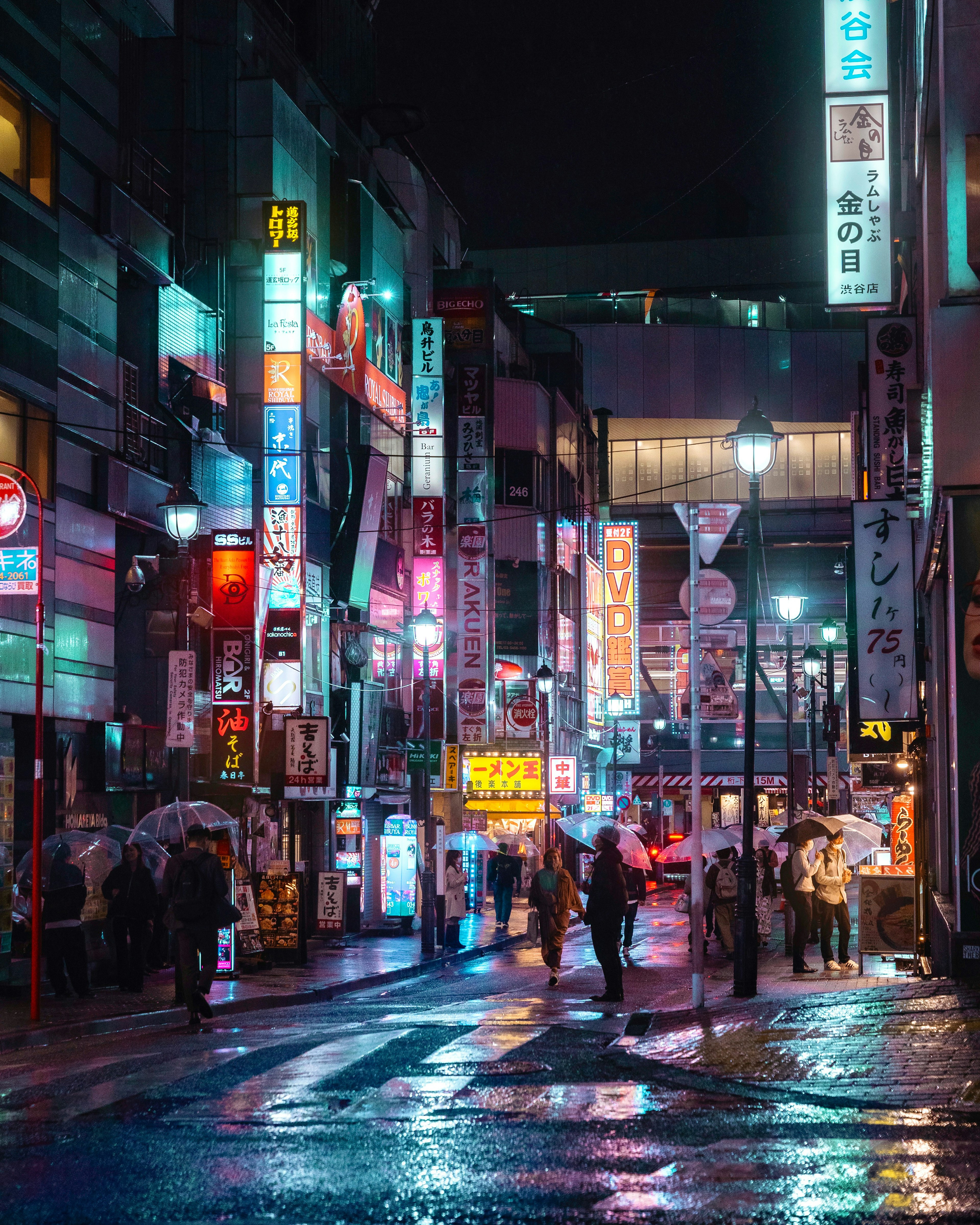 夜の街並みに輝くネオン看板と雨に濡れた道