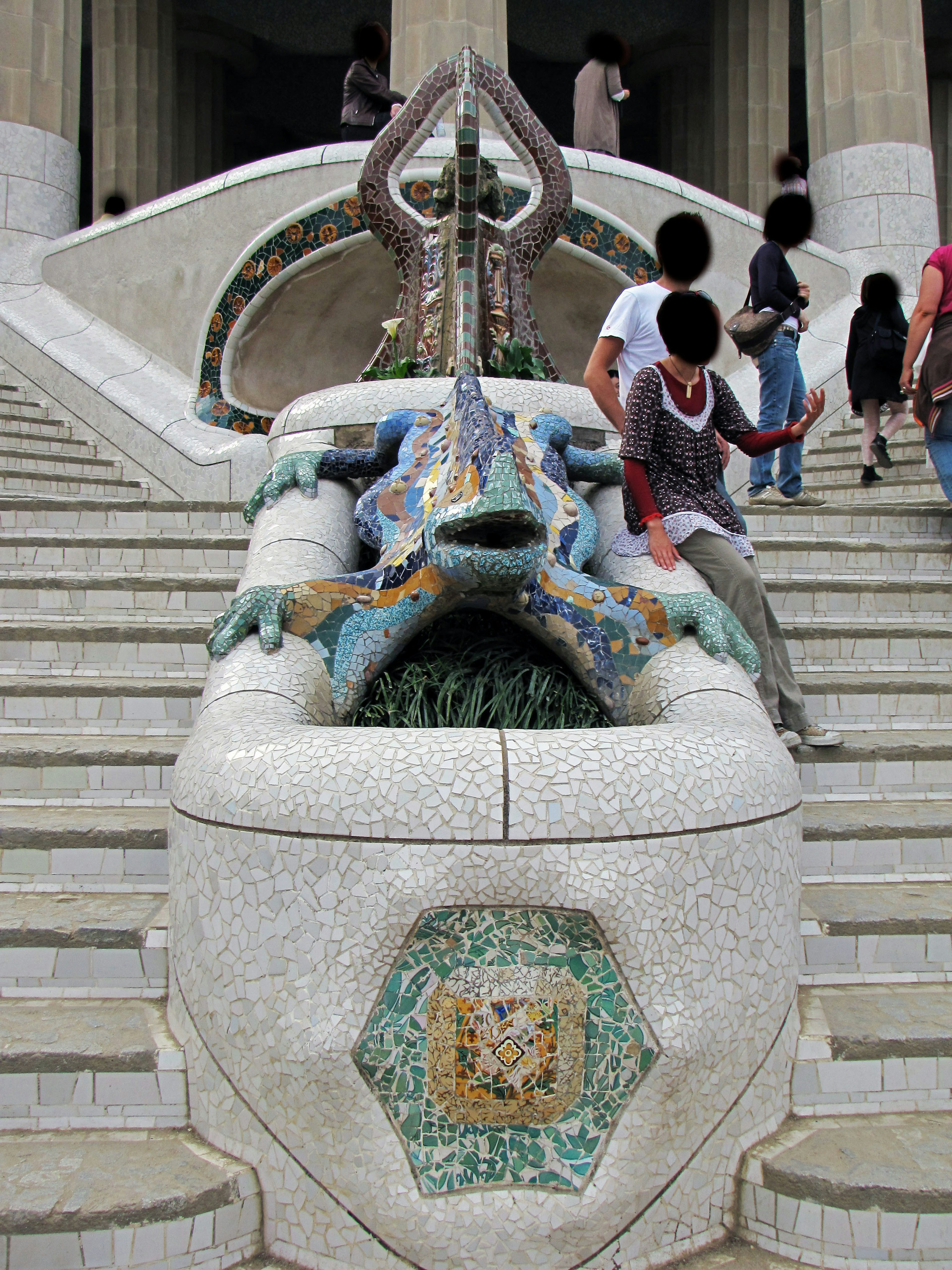 Dragon sculpture as a decoration on the stairs with surrounding people