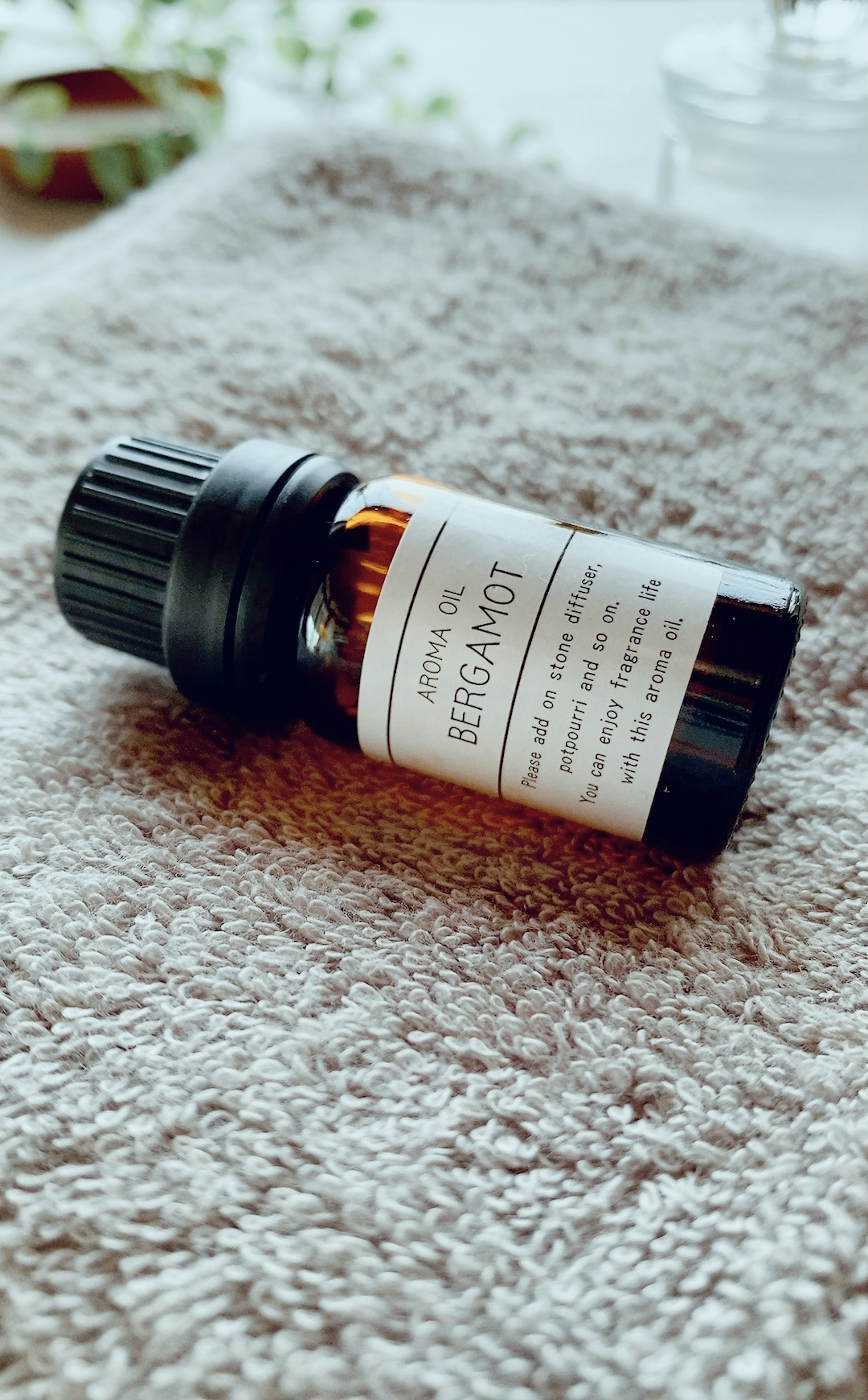 Essential oil bottle resting on a soft towel