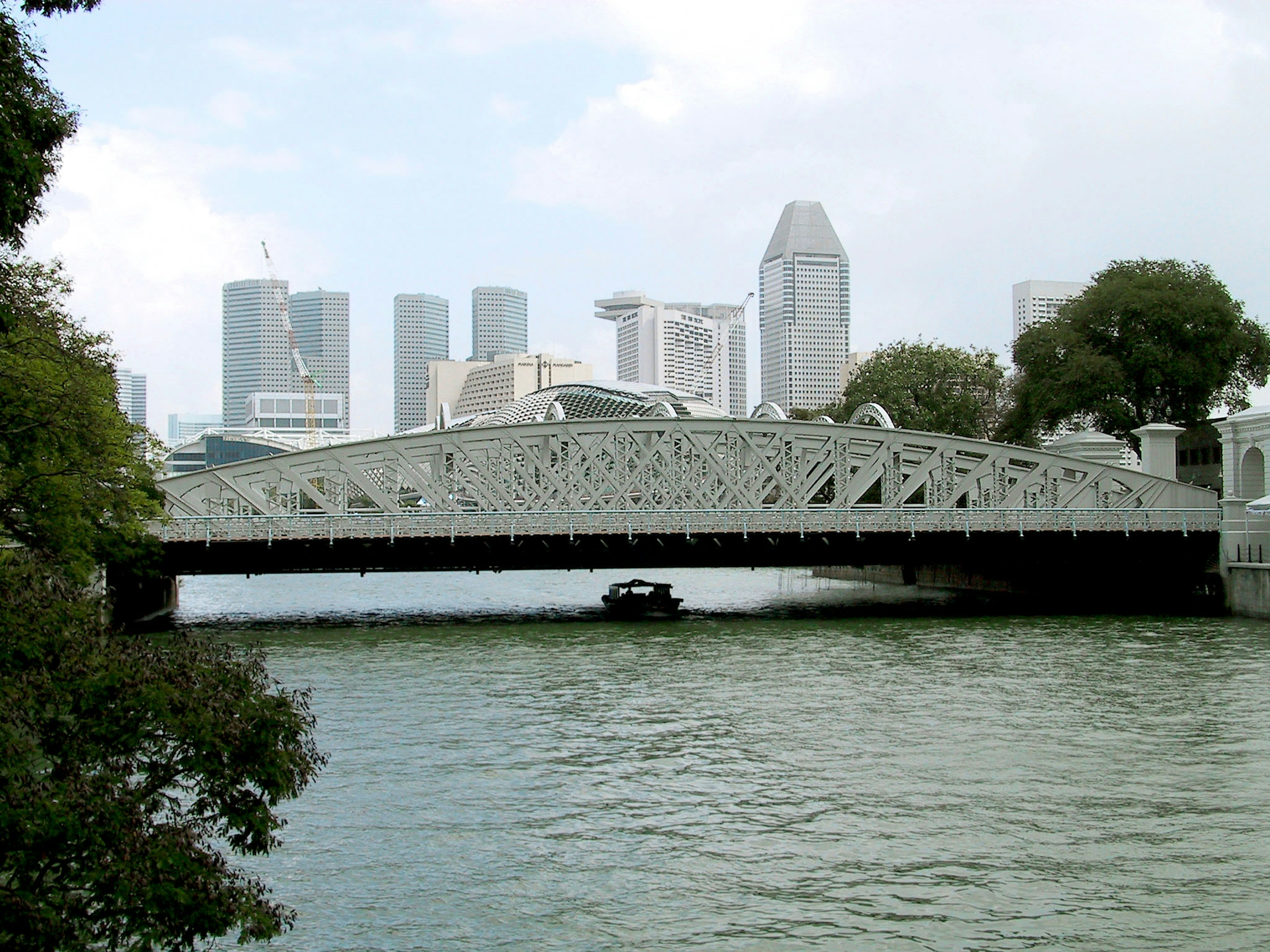 Bridge over water with modern skyscrapers in the background