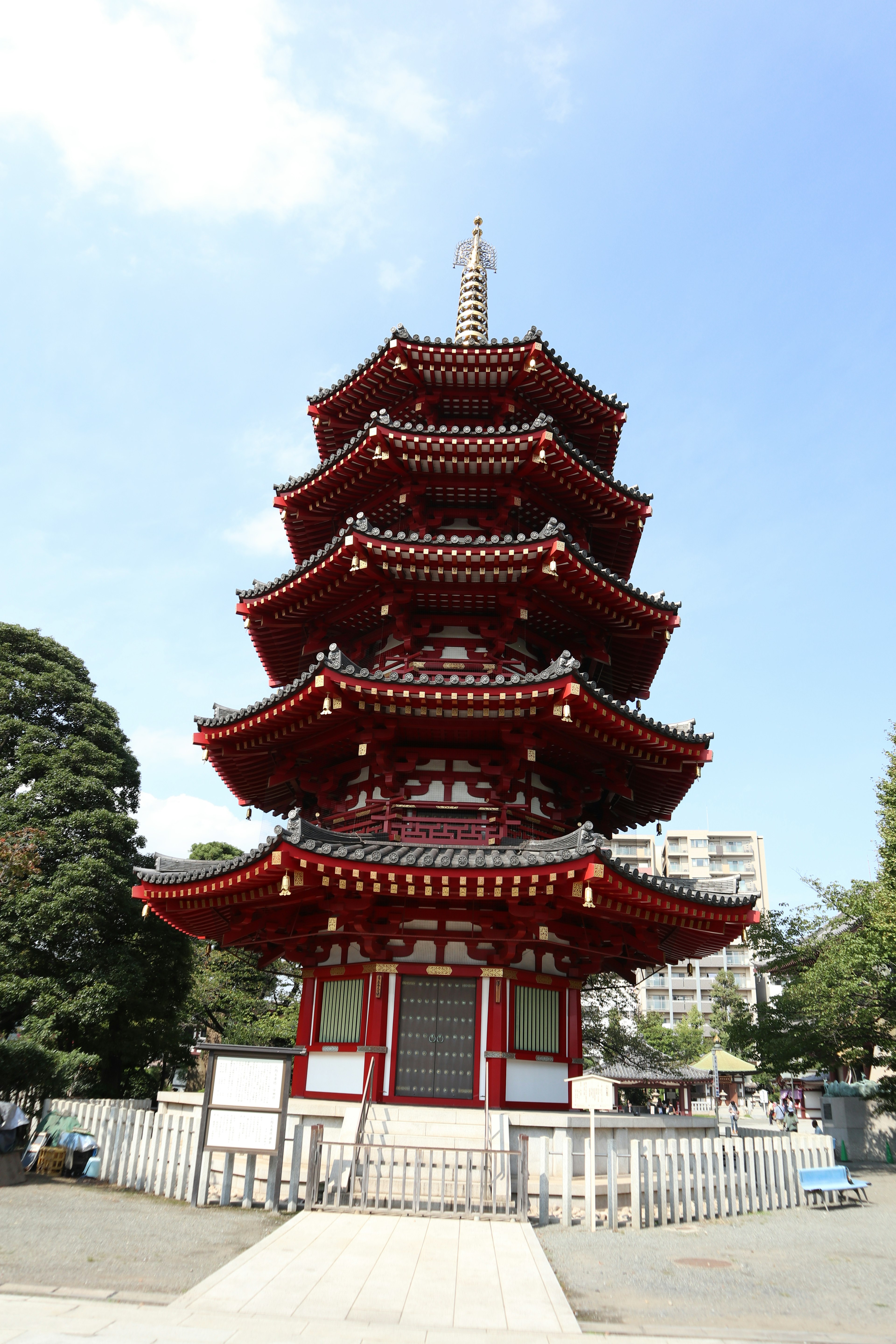 赤い五重塔が青空の下にそびえ立つ風景