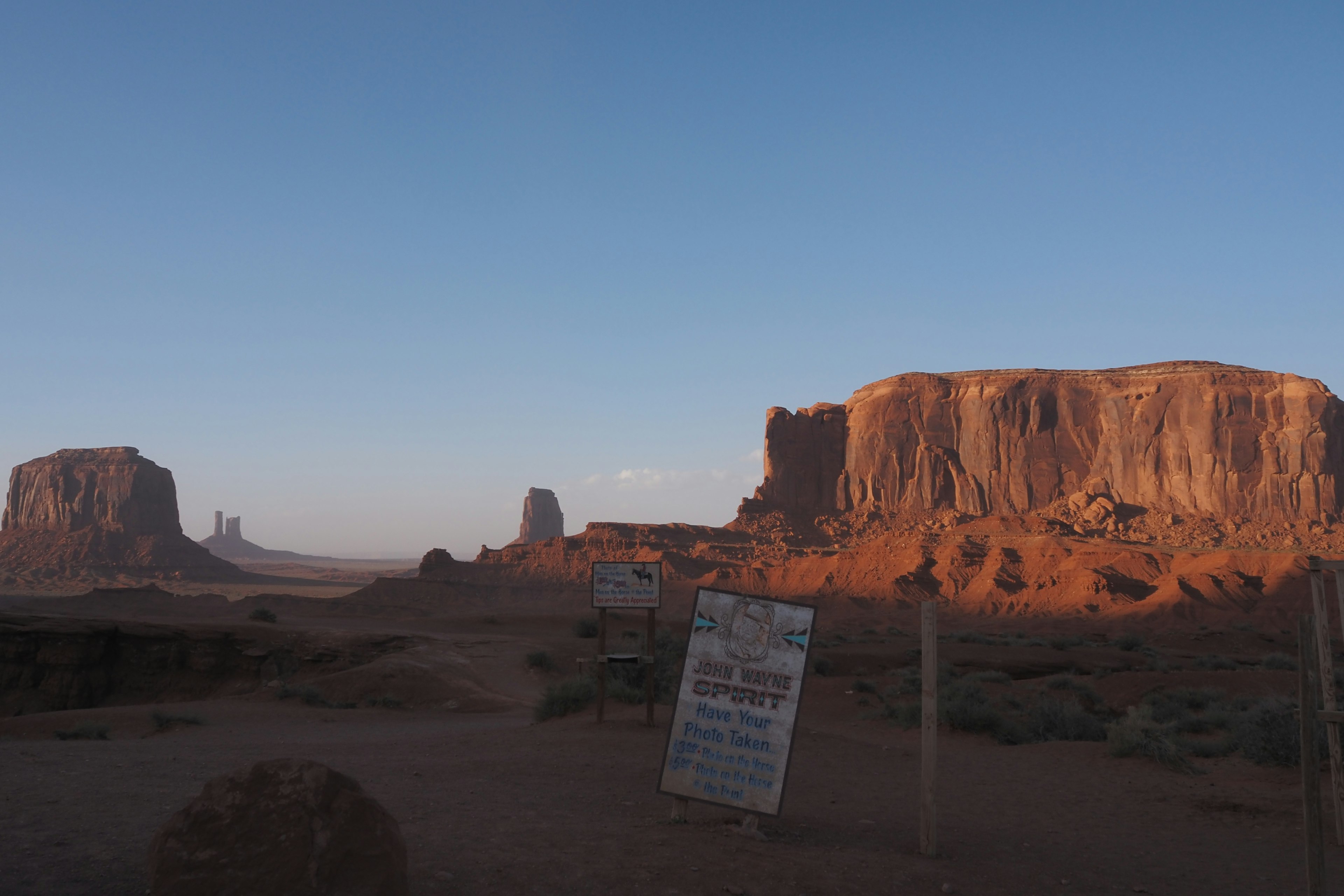 Red rock formations of Monument Valley under a clear blue sky