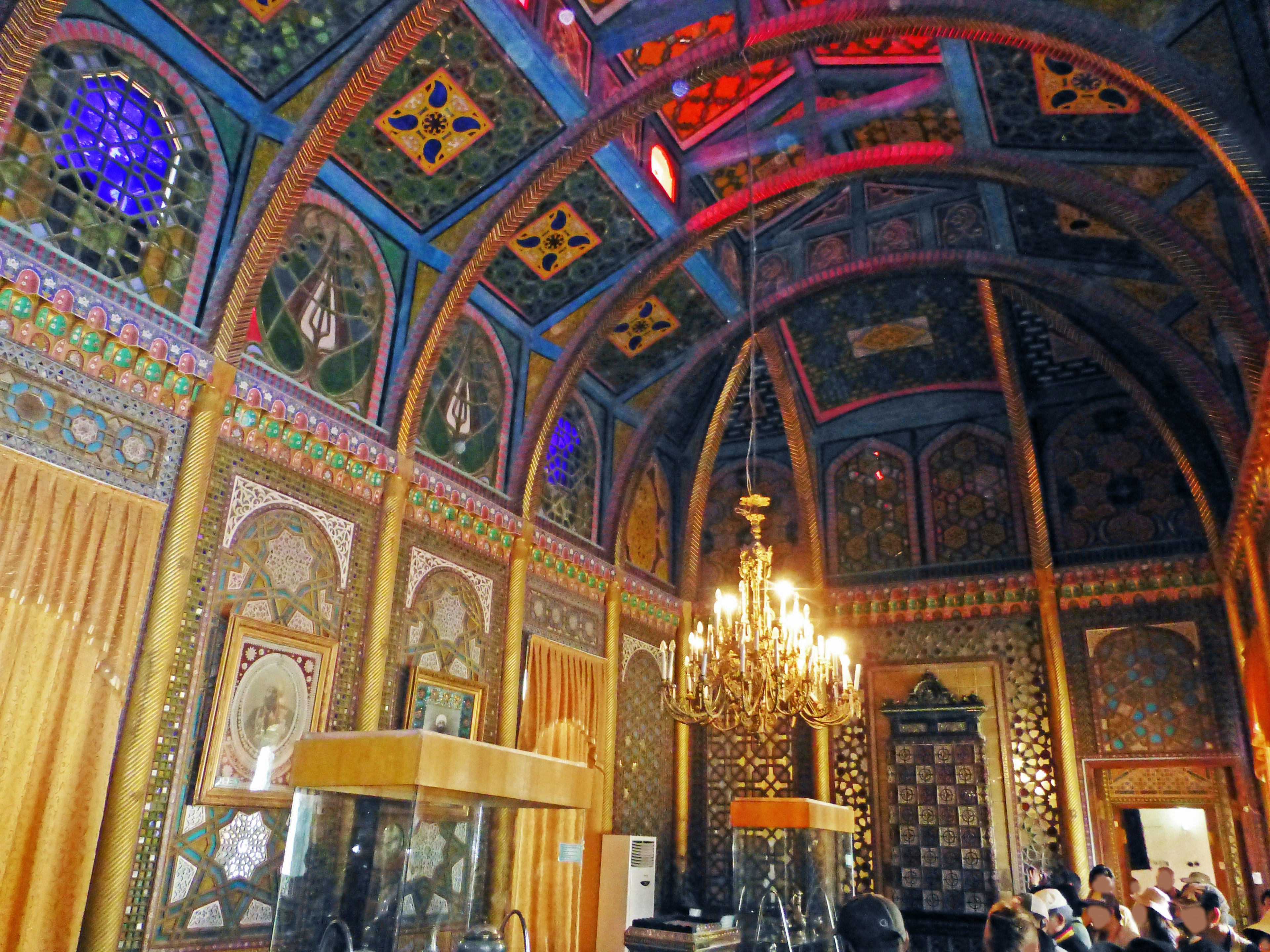 Luxurious room featuring decorative ceiling and colorful stained glass