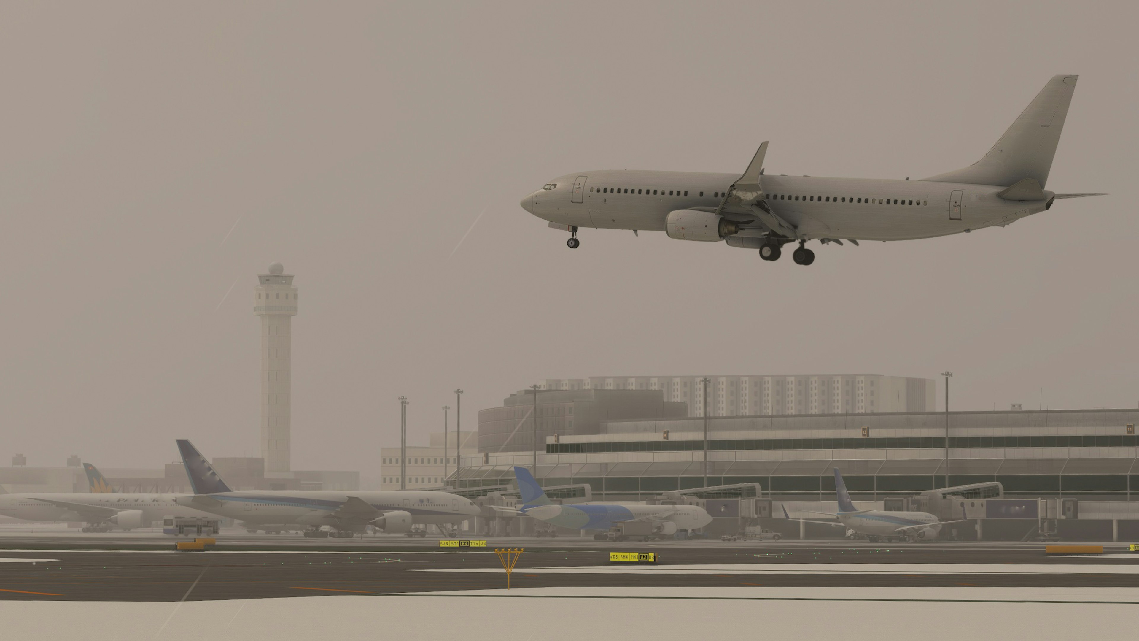 An airplane landing at an airport during snowfall