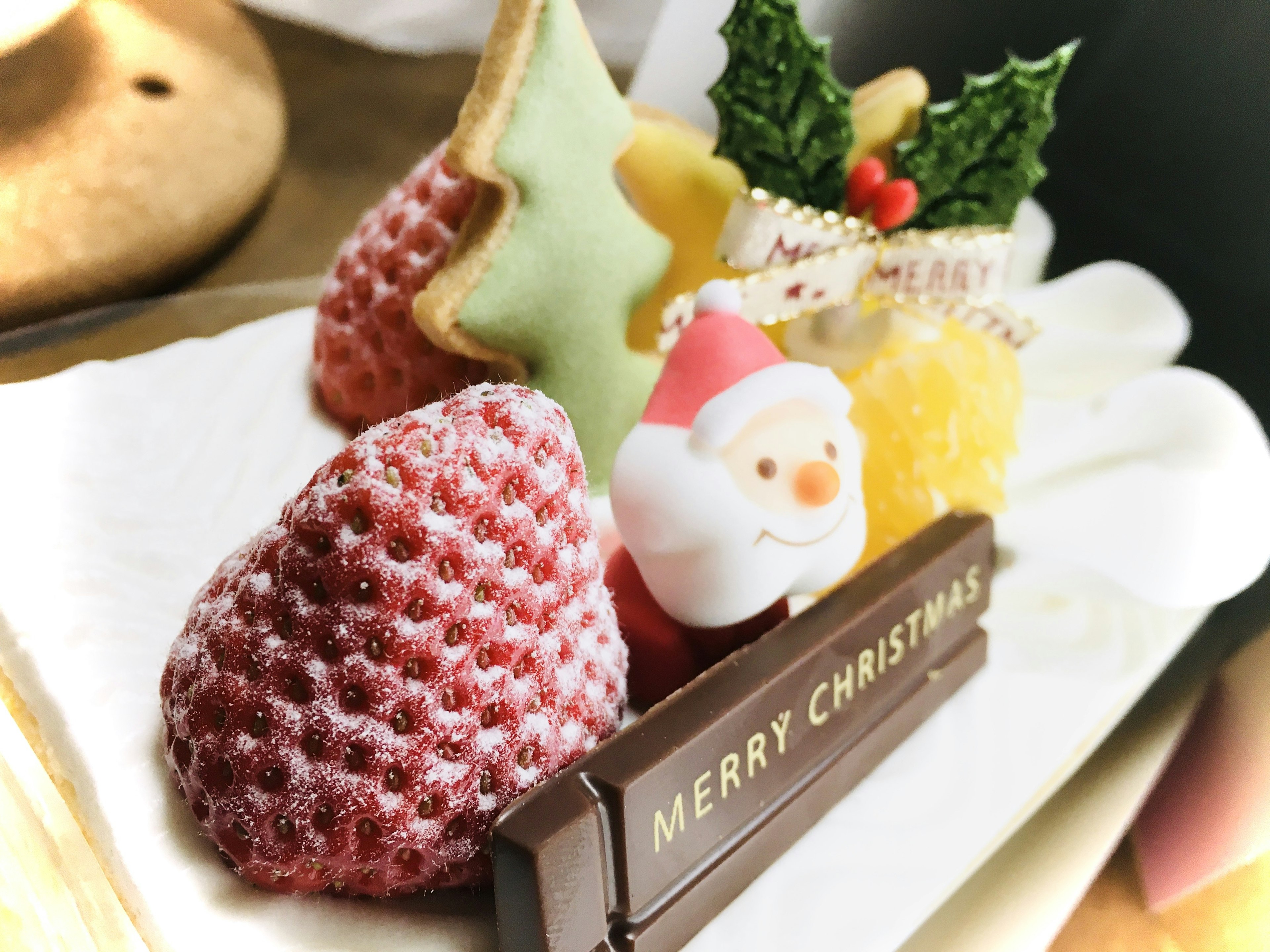 Christmas-themed dessert featuring Santa chocolate and decorated fruits