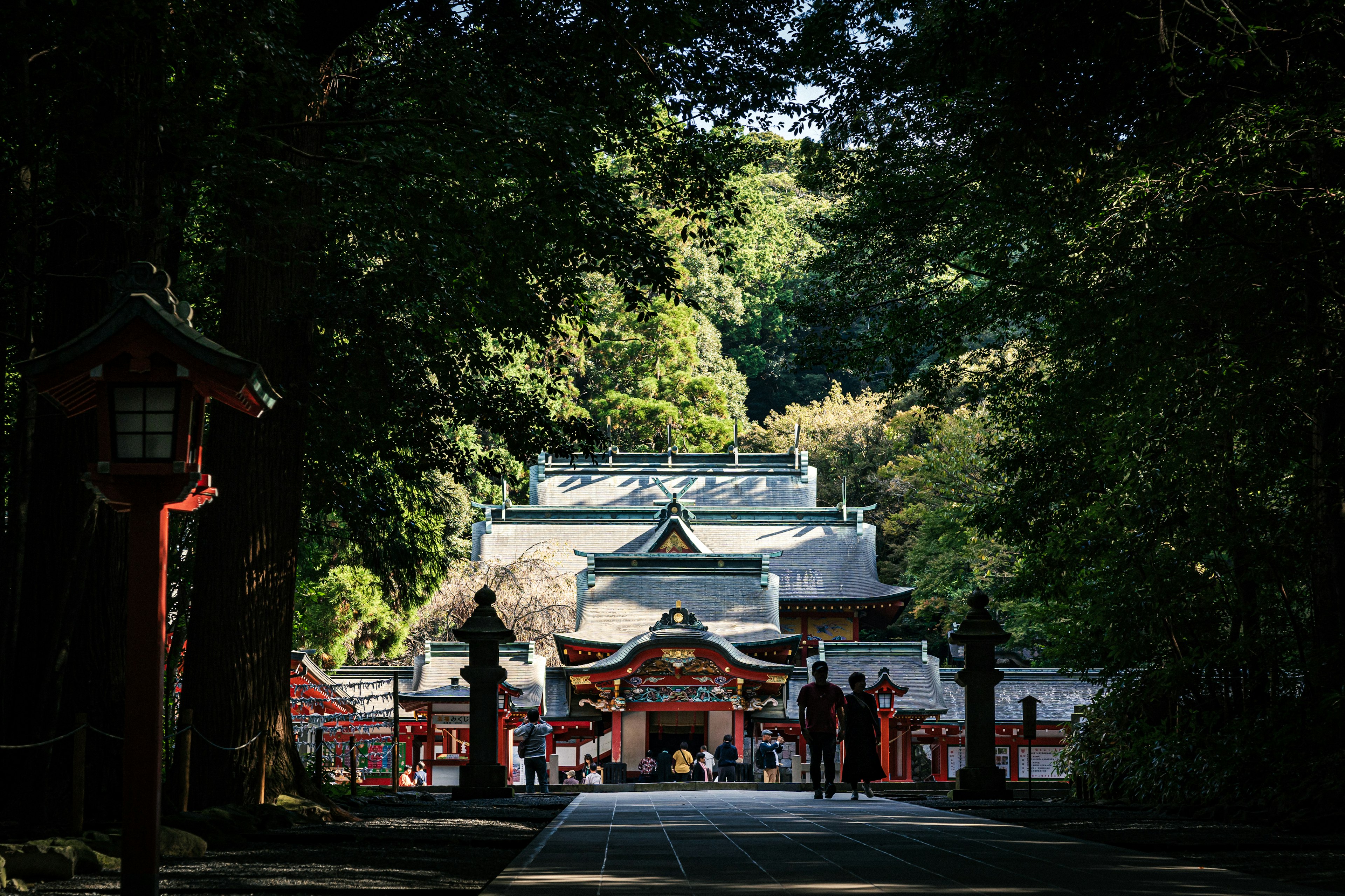 Main entrance of a shrine surrounded by trees and pathway