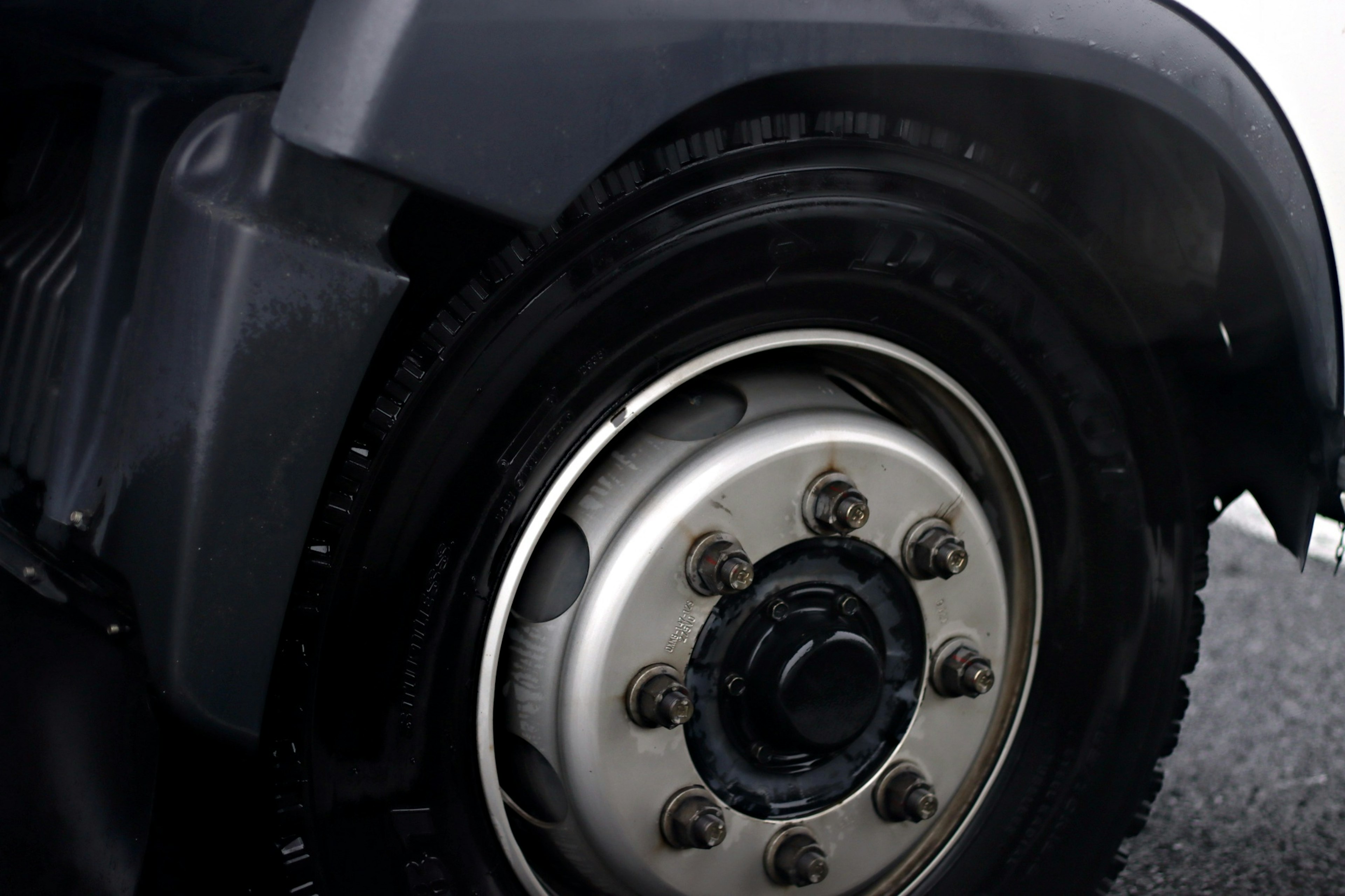 Close-up image of a truck wheel featuring a silver rim and black tire