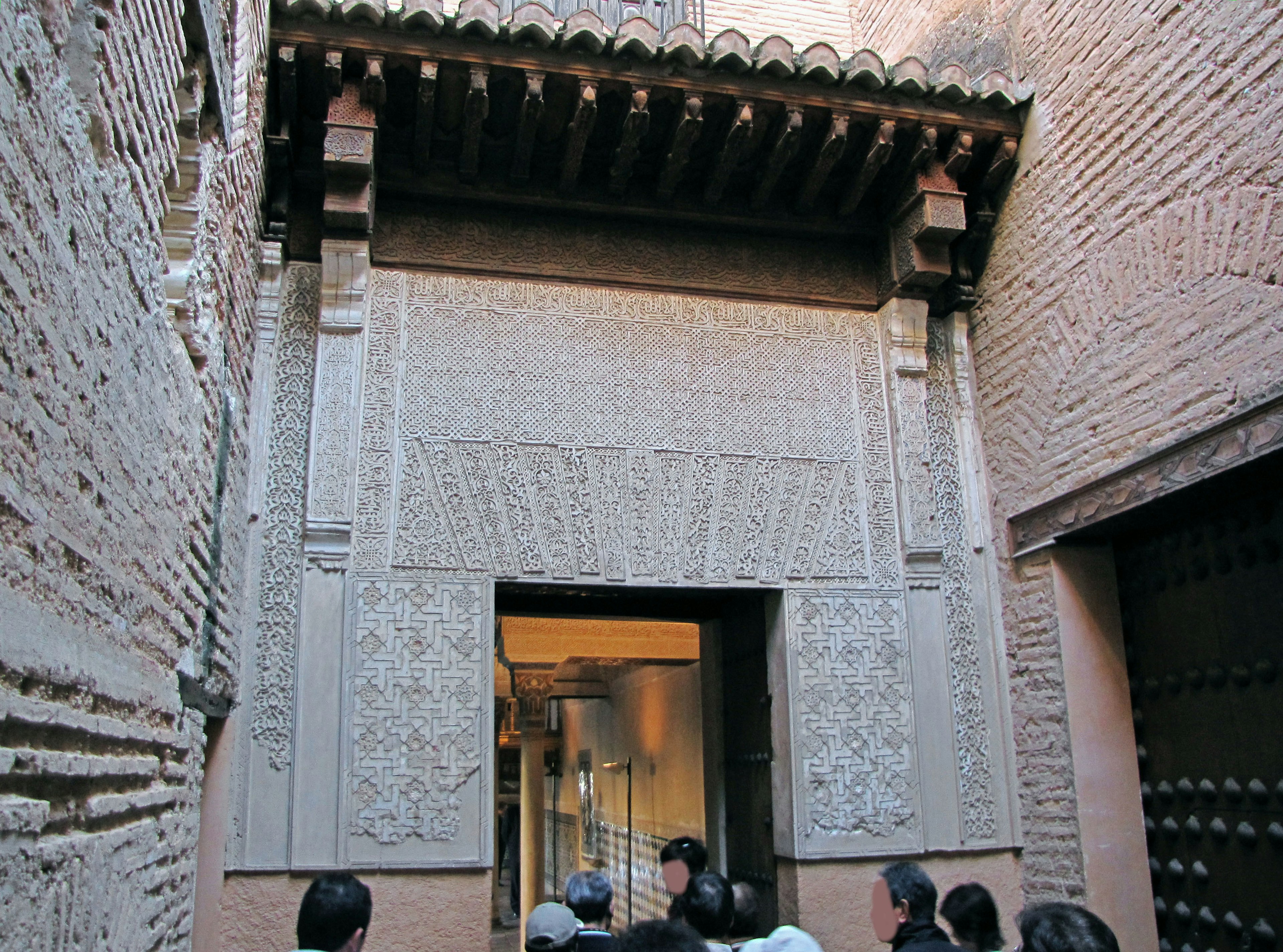 Historical building featuring a decorative entrance and detailed surrounding walls