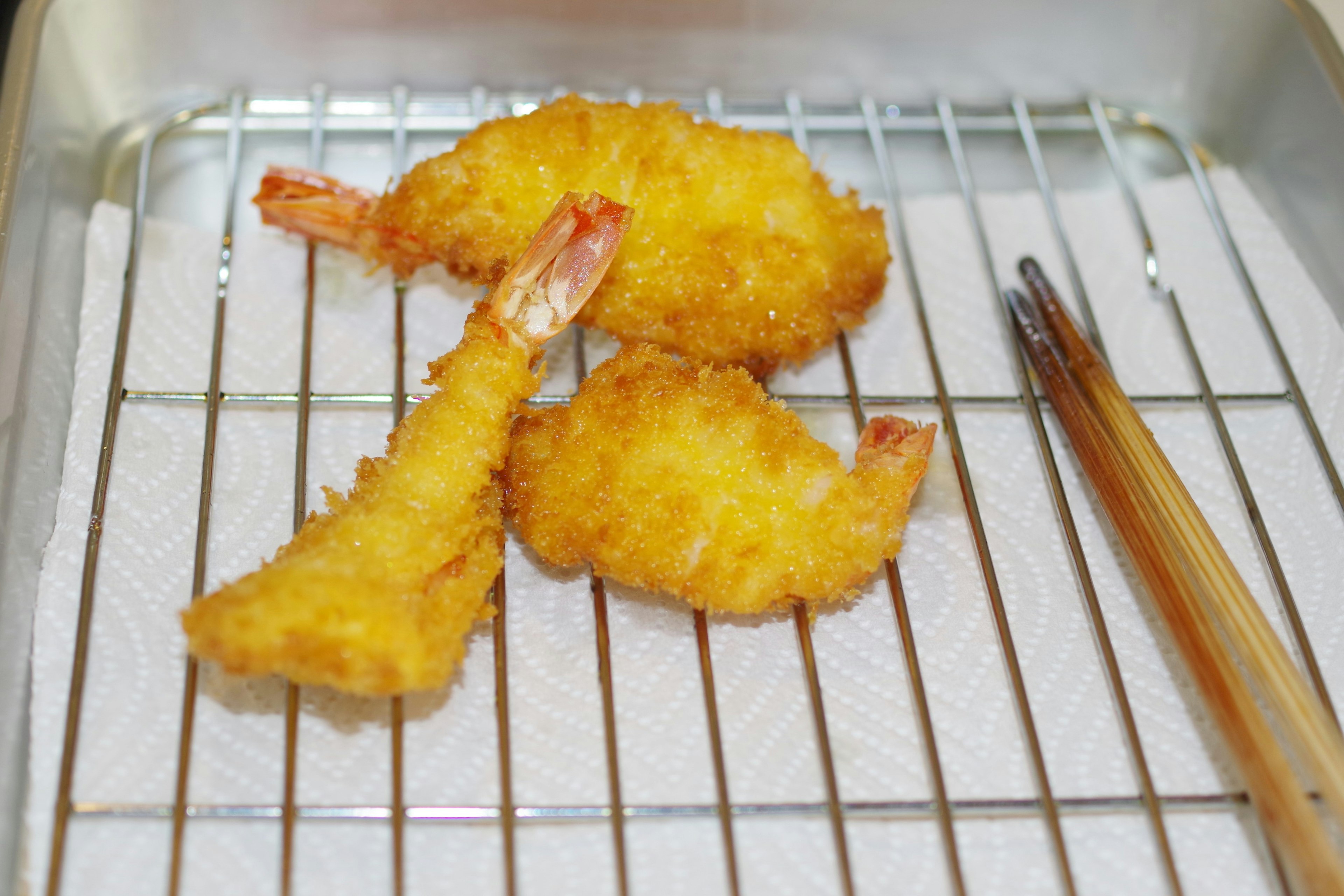 Fried shrimp placed on a rack