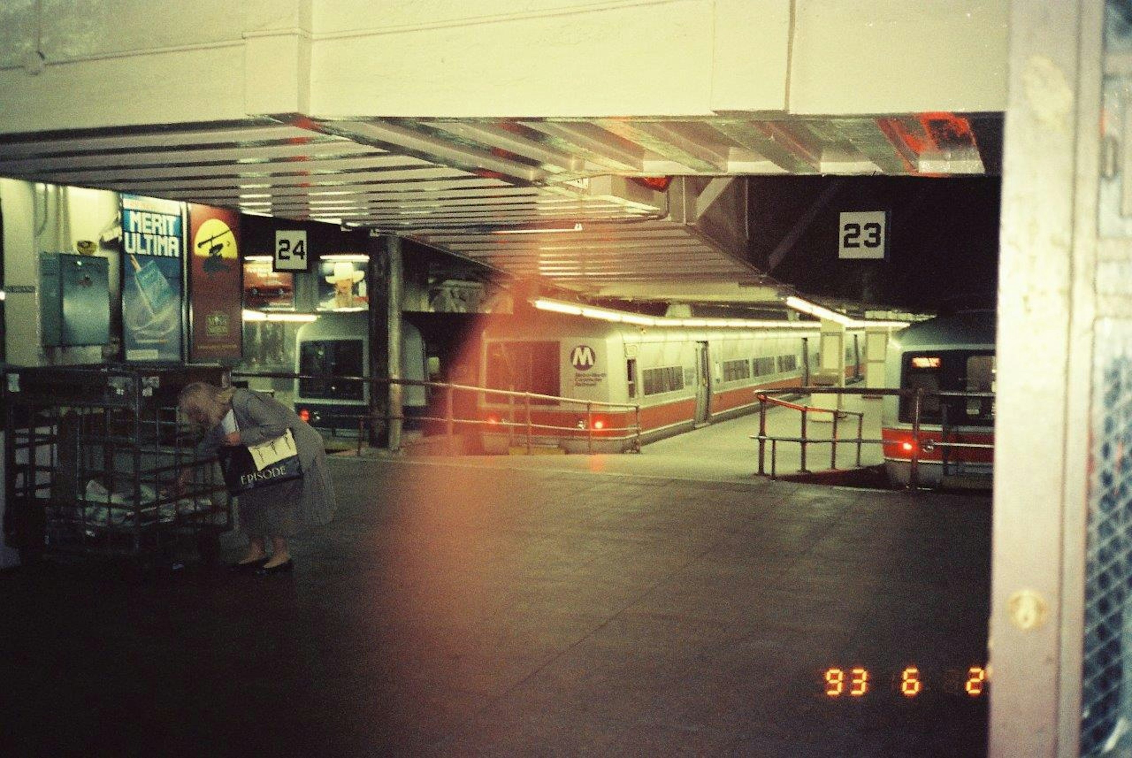 Platform scene with a stationary train and people at a railway station