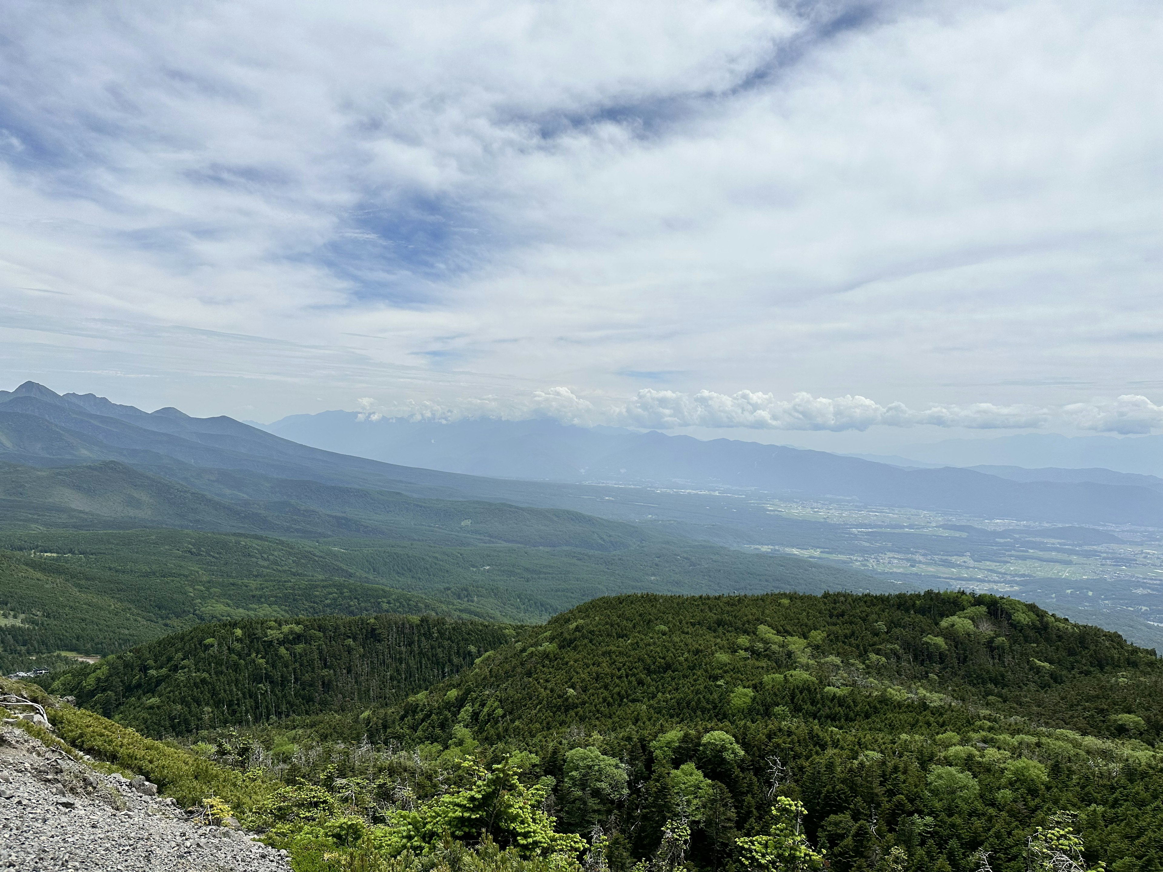 山々と緑の丘の美しい風景が広がる青空の下の自然景観