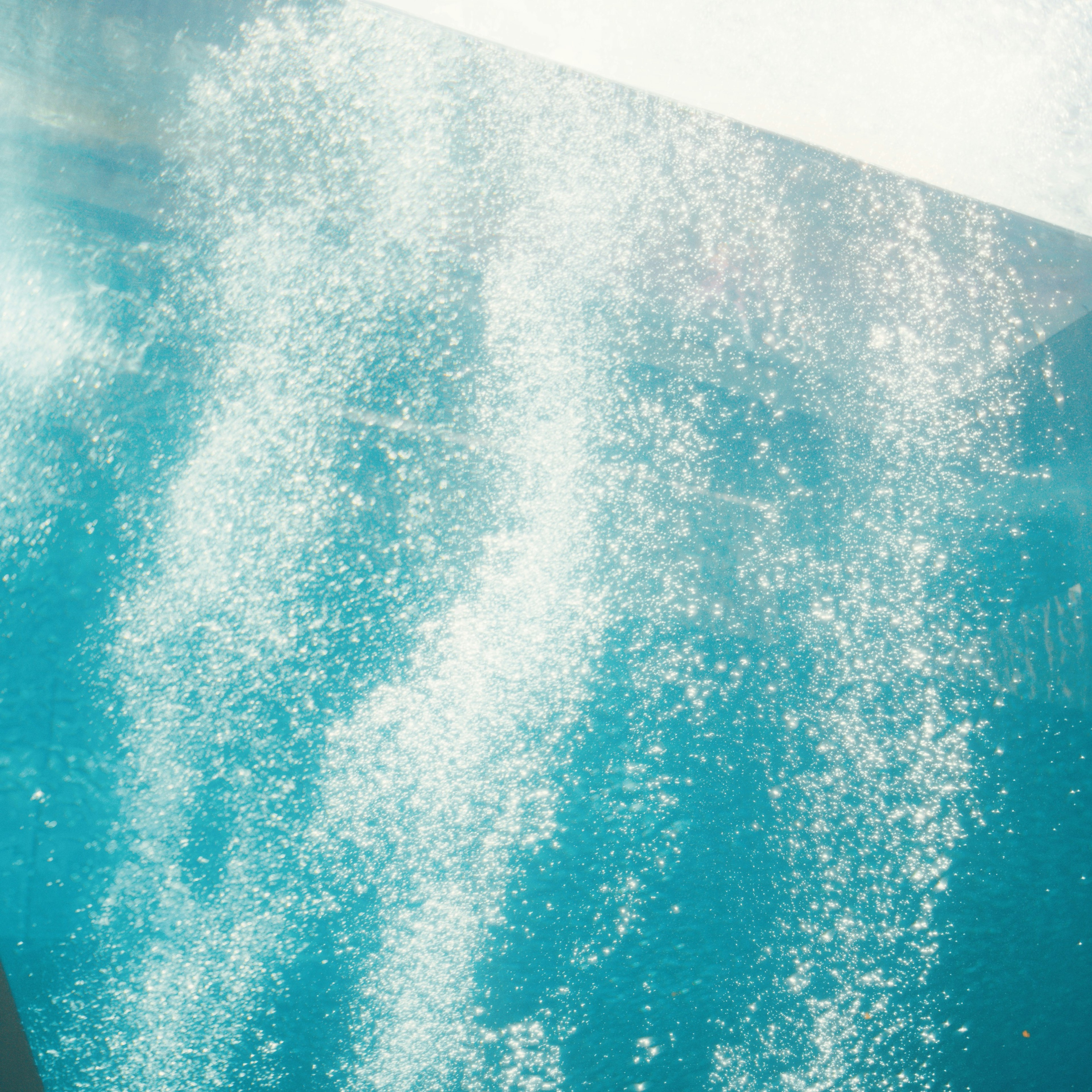 Image of sparkling bubbles in blue water