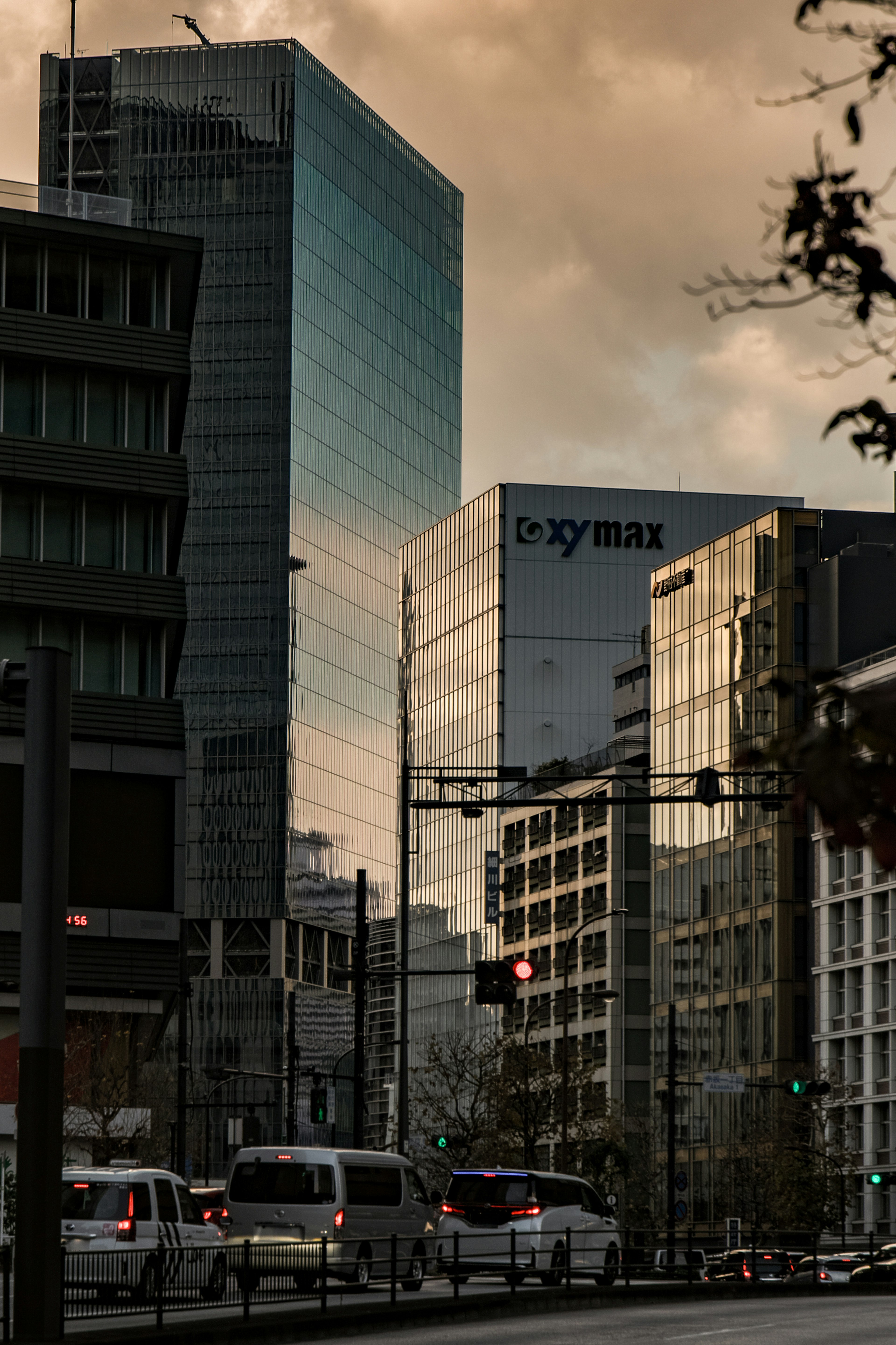 Modern glass buildings in an urban setting with a sunset sky