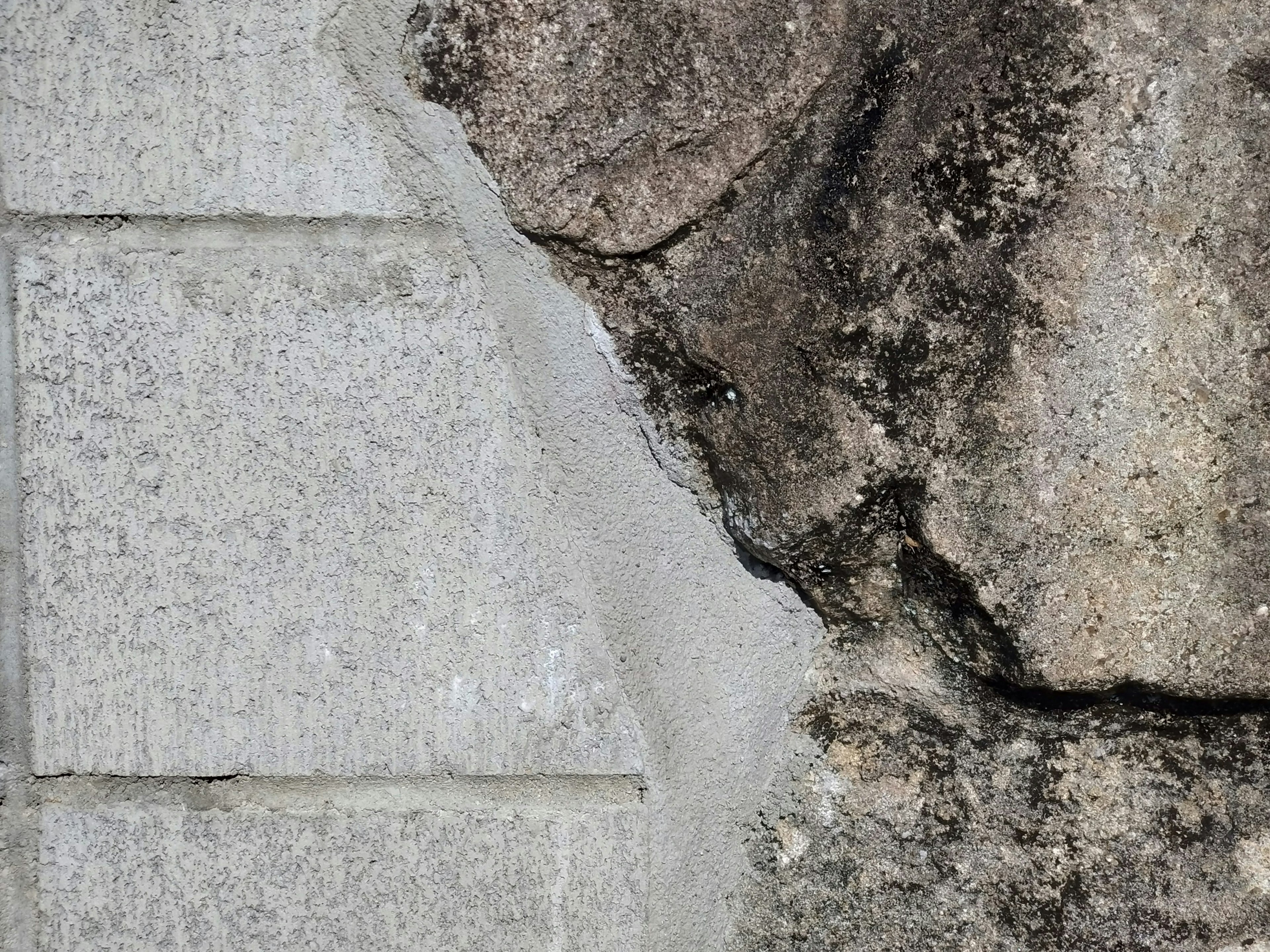 Contrast of concrete wall and rock texture