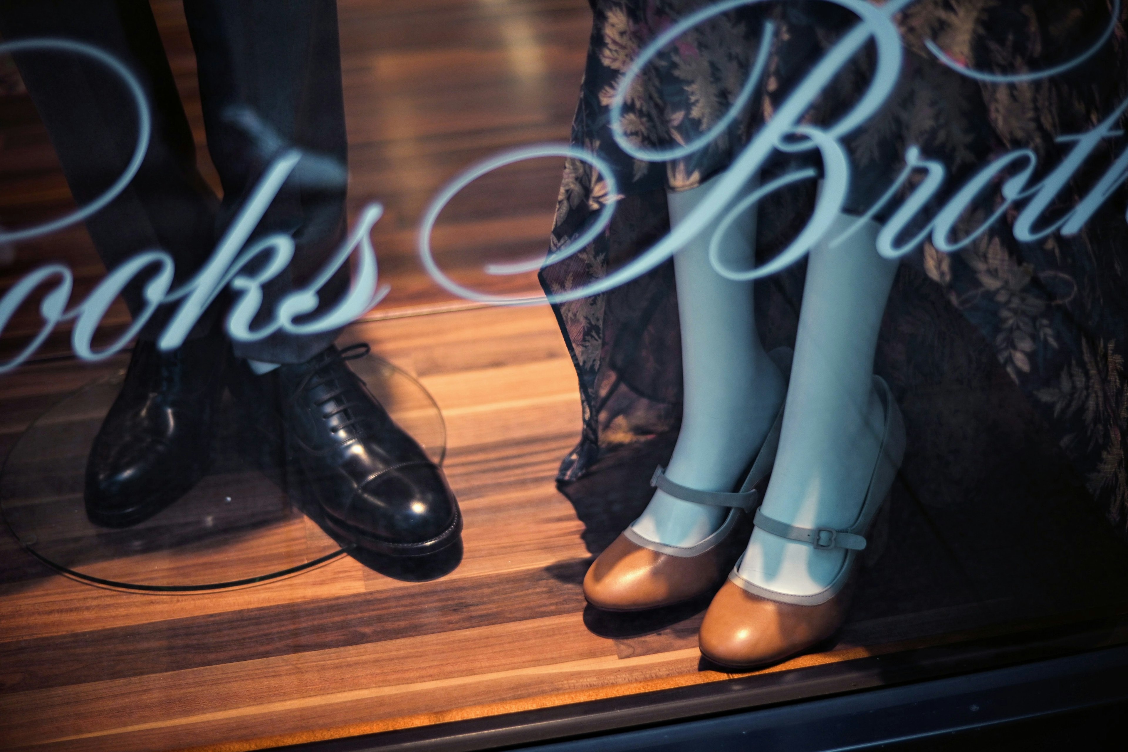 Men's and women's shoes displayed in a Brooks Brothers window