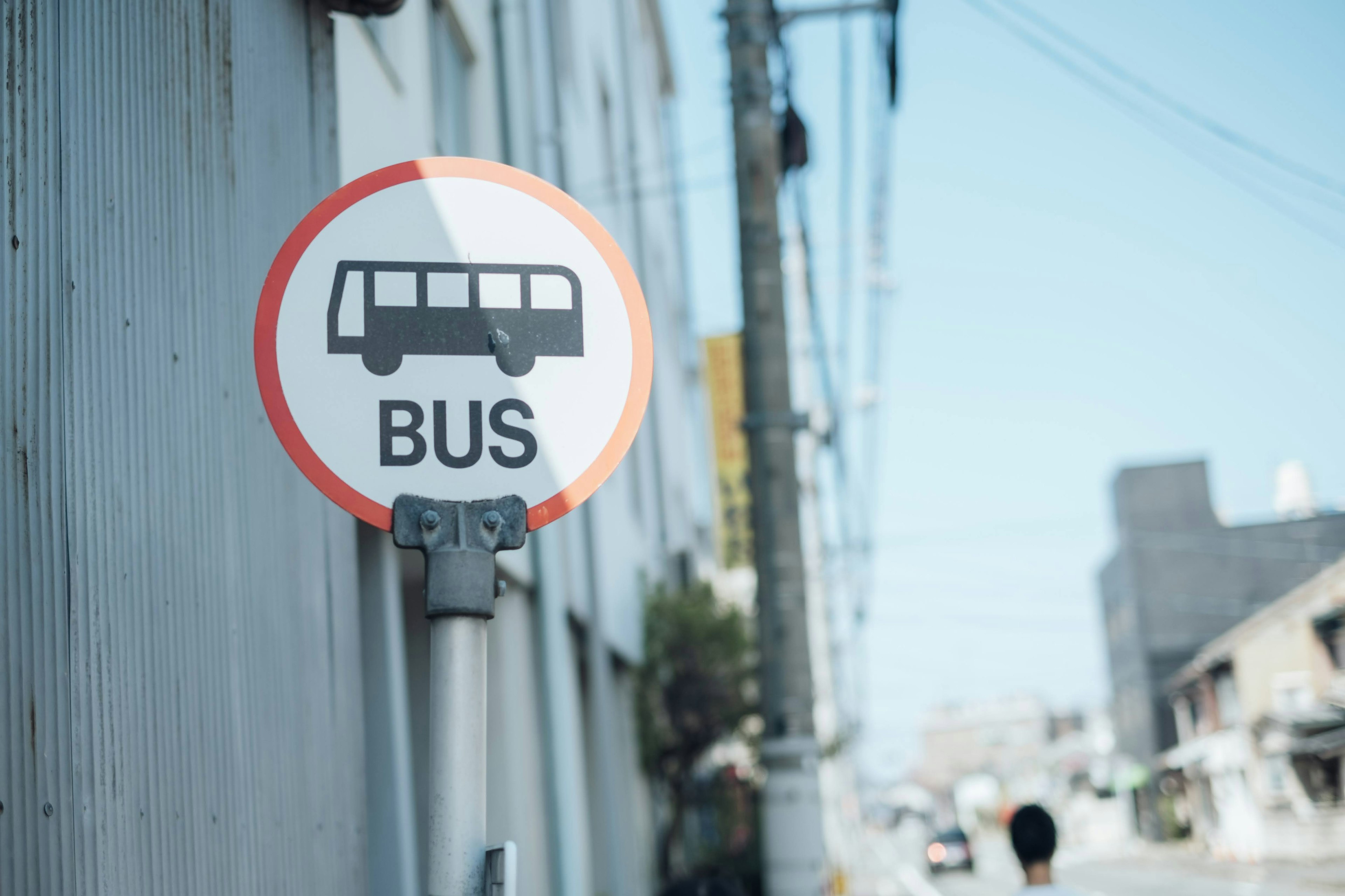 A bus stop sign in an urban setting